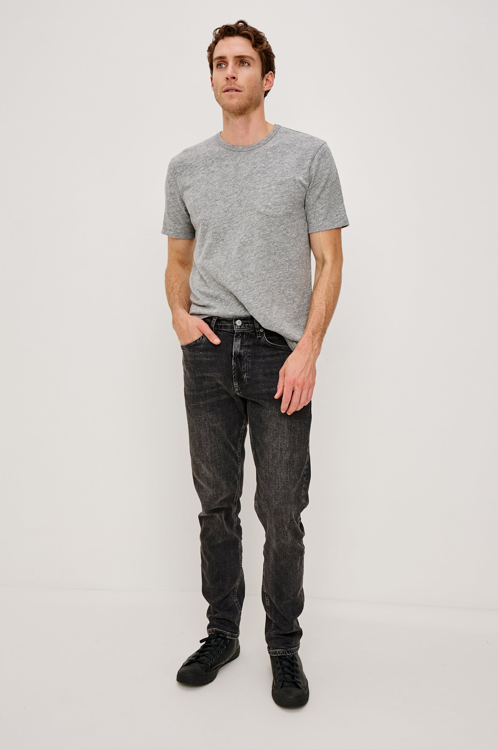 Clayton Slim Straight is a Classic 5-Pocket Jean in Faded Onyx Colorway, a Washed Black. Front Full Body View Featured on Model.