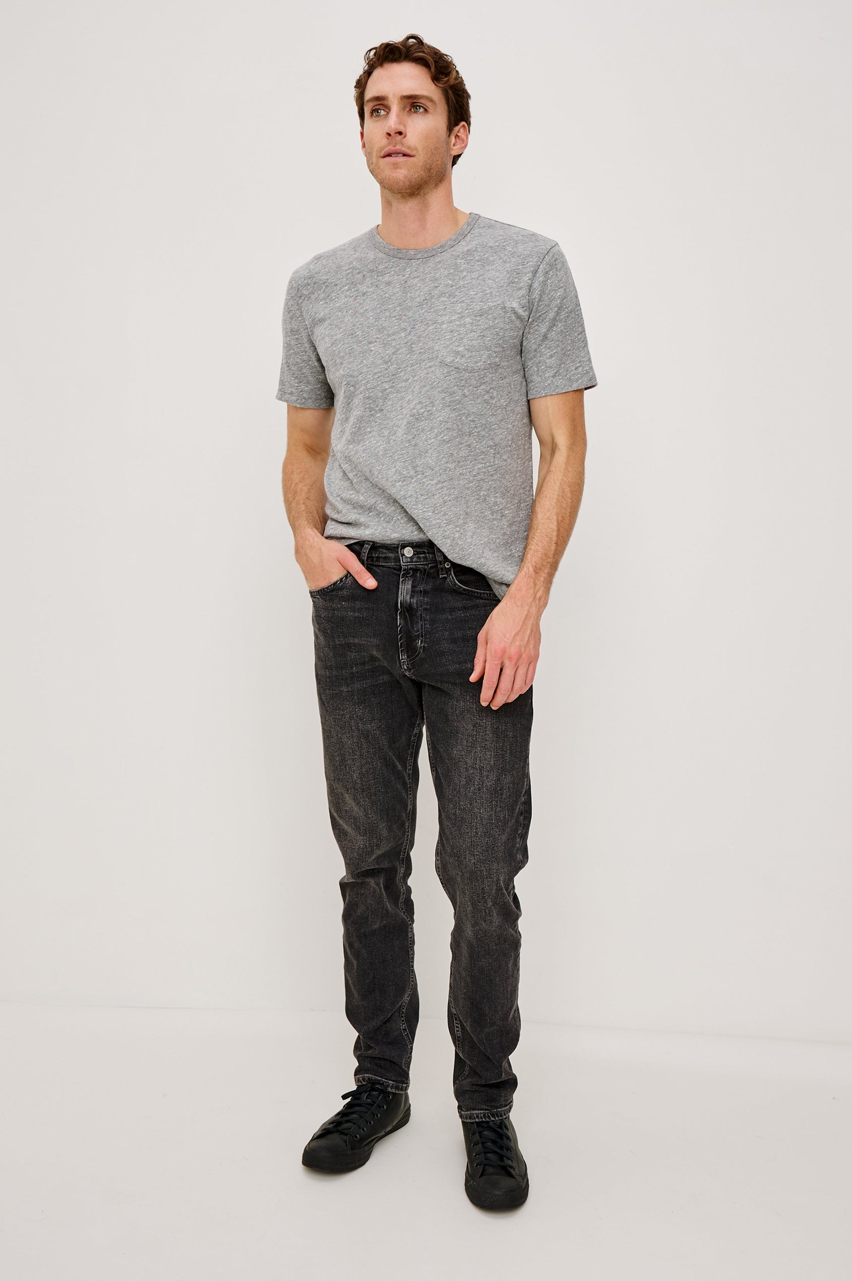 Clayton Slim Straight is a Classic 5-Pocket Jean in Faded Onyx Colorway, a Washed Black. Front Full Body View Featured on Model.