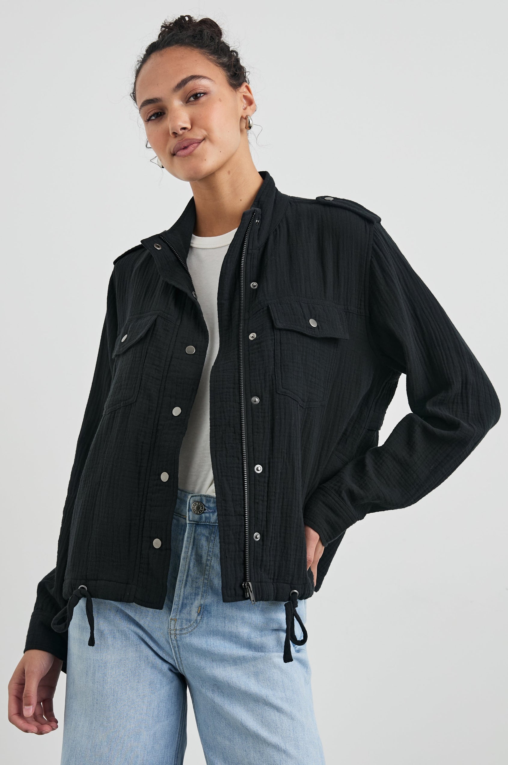 Collins Jacket with Zip and Snap Closure, Two Chest Snap Flap Pockets, Toggle Drawstring Hem, Snap Shoulder Straps and a Breathable Back Flap in Gauze Black Colorway - Front View Featured on Model