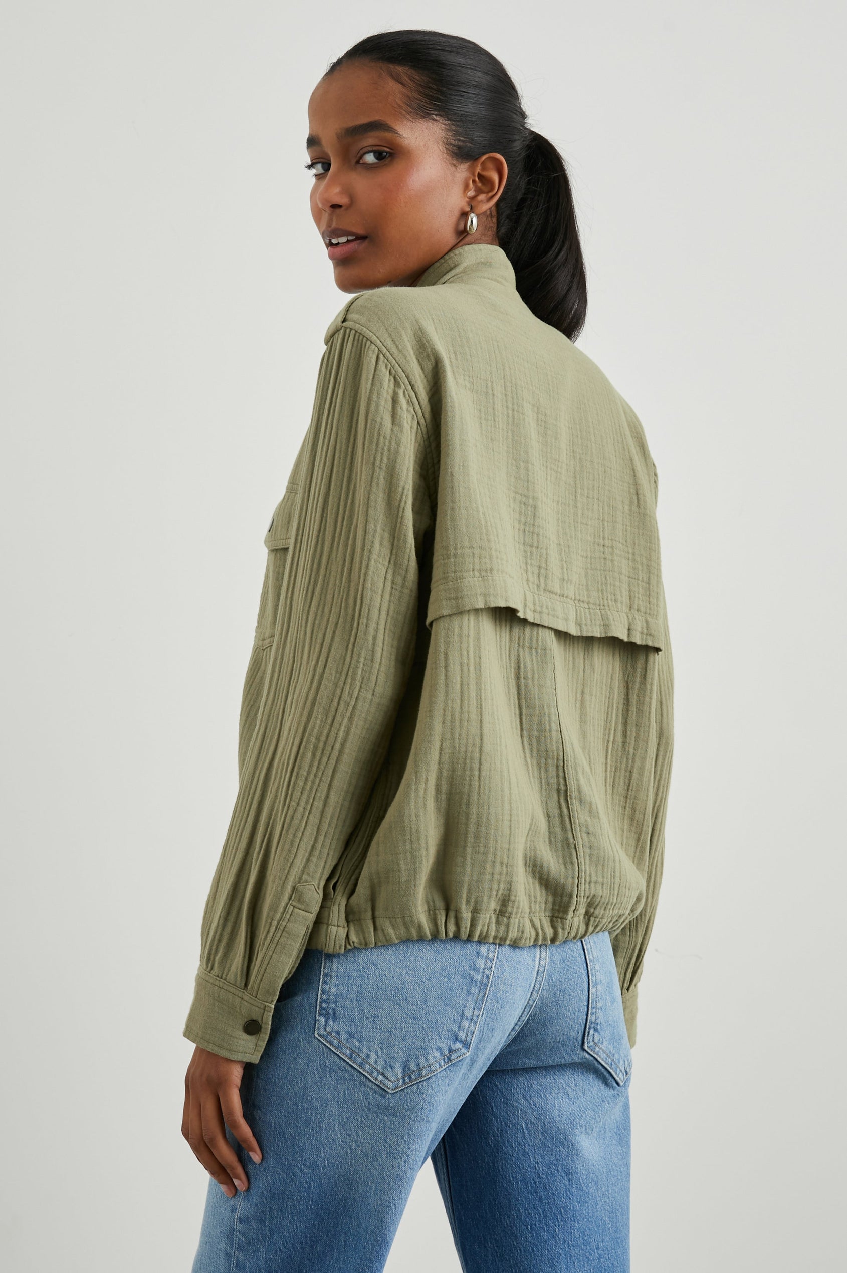 Collins Jacket with Zip and Snap Closure, Two Chest Snap Flap Pockets, Toggle Drawstring Hem, Snap Shoulder Straps and a Breathable Back Flap in Gauze Mermaid Colorway - Back View Featured on Model