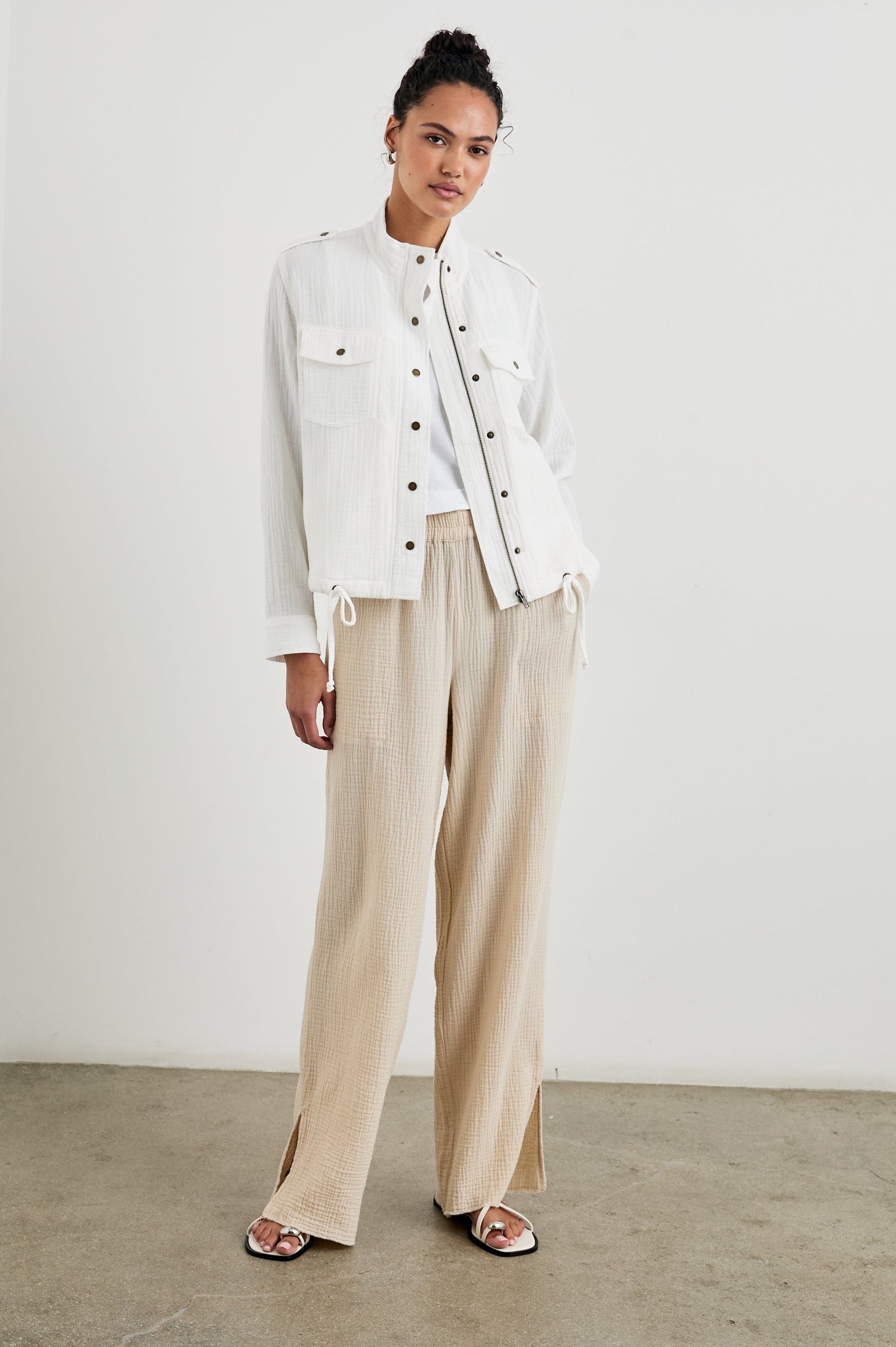 Collins Jacket with Zip and Snap Closure, Two Chest Snap Flap Pockets, Toggle Drawstring Hem, Snap Shoulder Straps and a Breathable Back Flap in Gauze White Colorway - Front Full Body View Featured on Model