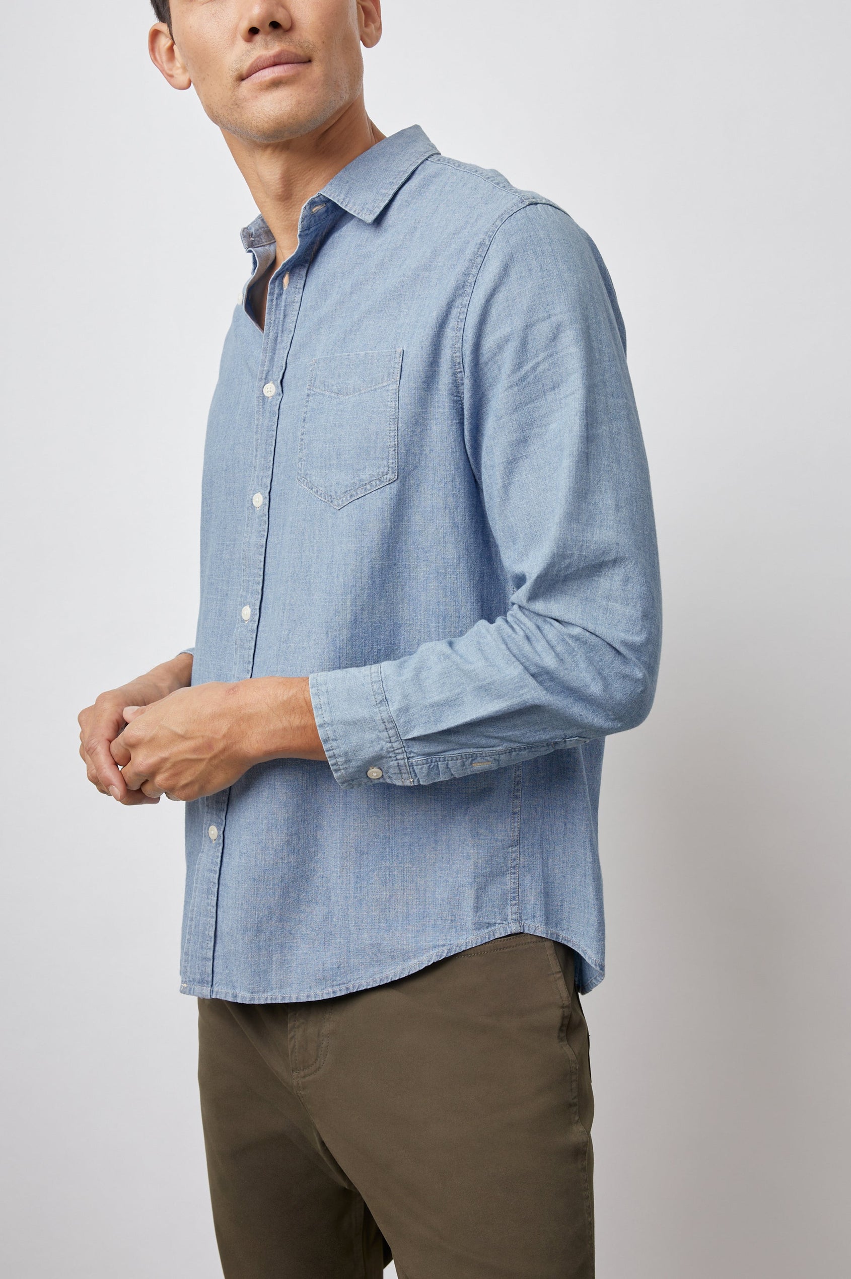 Colton Long-Sleeve Denim Button Up with a Chest Patch Pocket in Medium Vintage Wash Colorway - Side View Featured on Model 