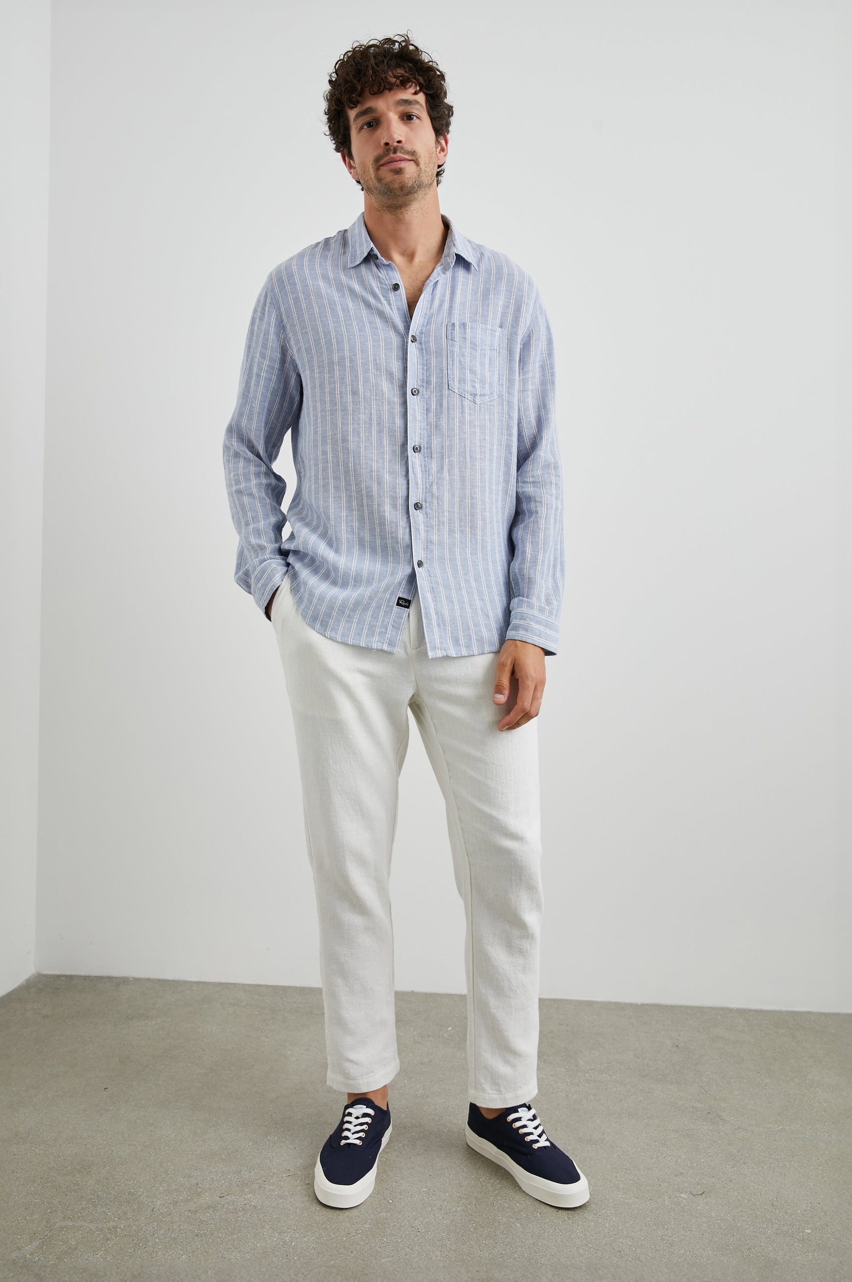 Connor Long-Sleeve Button Up with a Chest Patch Pocket in Denim White Pinstripe Colorway - Front Full Body View Featured on Model