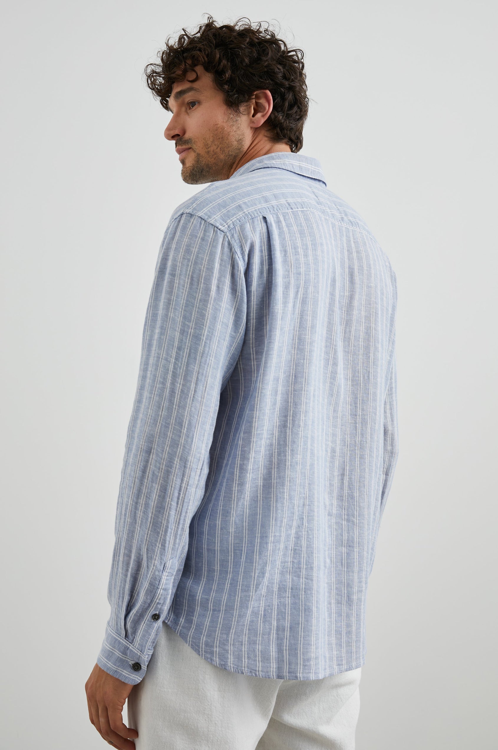 Connor Long-Sleeve Button Up with a Chest Patch Pocket in Denim White Pinstripe Colorway - Back View Featured on Model