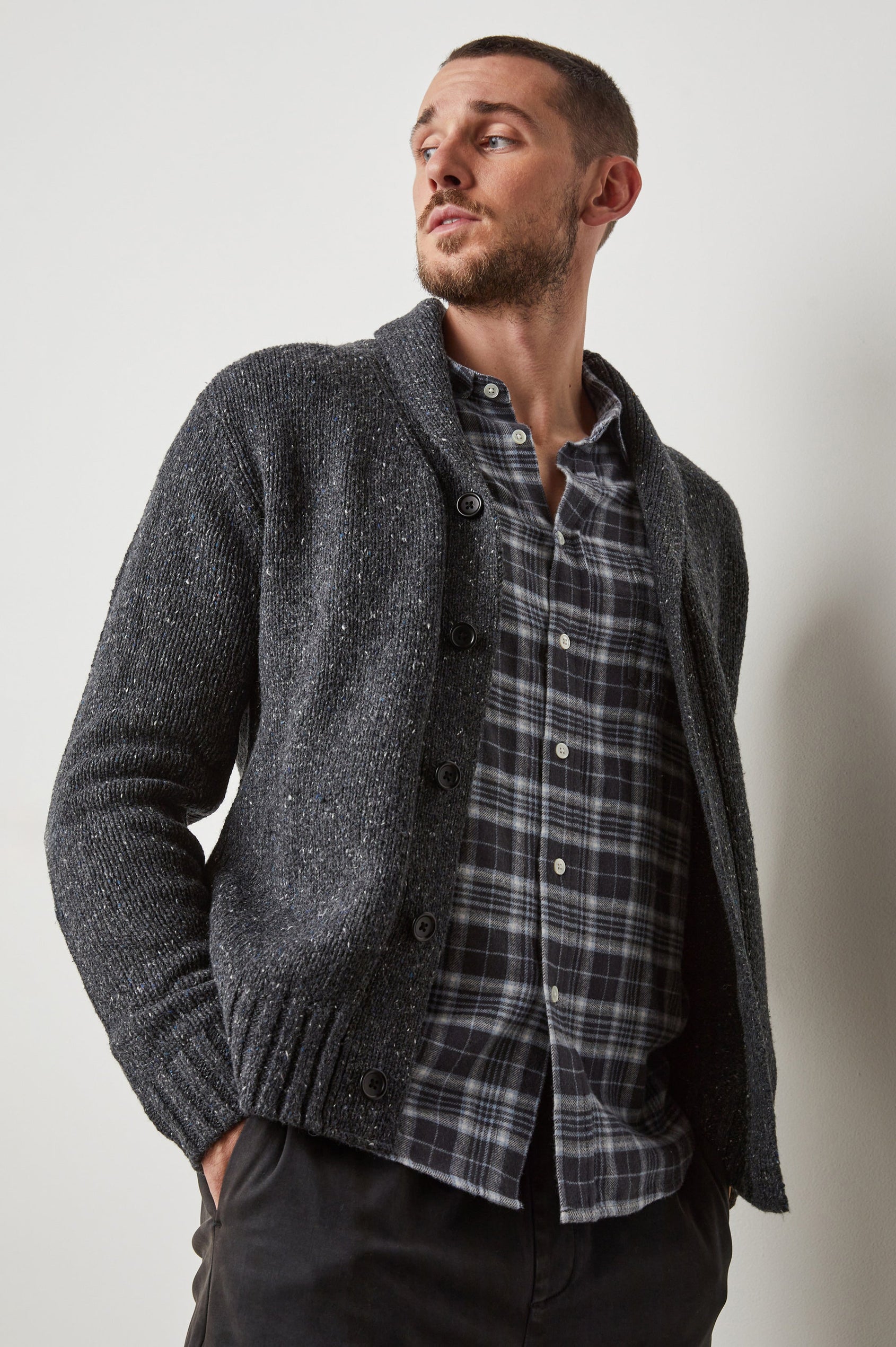 Corden Long-Sleeve Cardigan with Button Closure, a Shawl Collar and Ribbed Trim in Constellation Colorway, White and Blue Speckles on Dark Grey - Front View Featured on Model