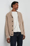 Corden Long-Sleeve Cardigan with Button Closure, a Shawl Collar and Ribbed Trim in Oatmeal Speckle Colorway - Front View Featured on Model