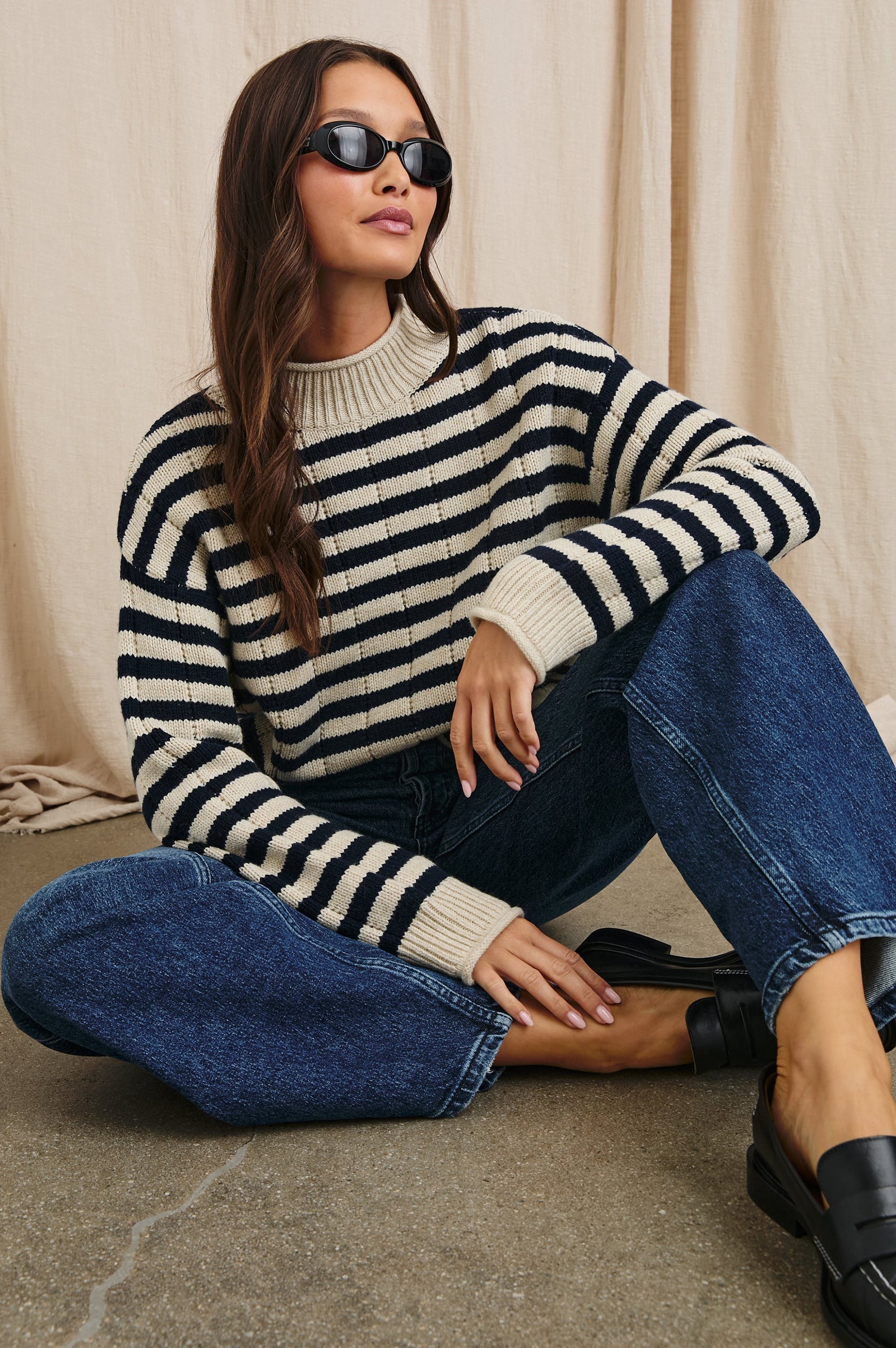 Corrine Long-Sleeve Sweater with Ribbed Trim and a Mock Neck in Oat Navy Stripe Colorway, Horizontal Stripes - Front Full Body View Featured on Seated Model 