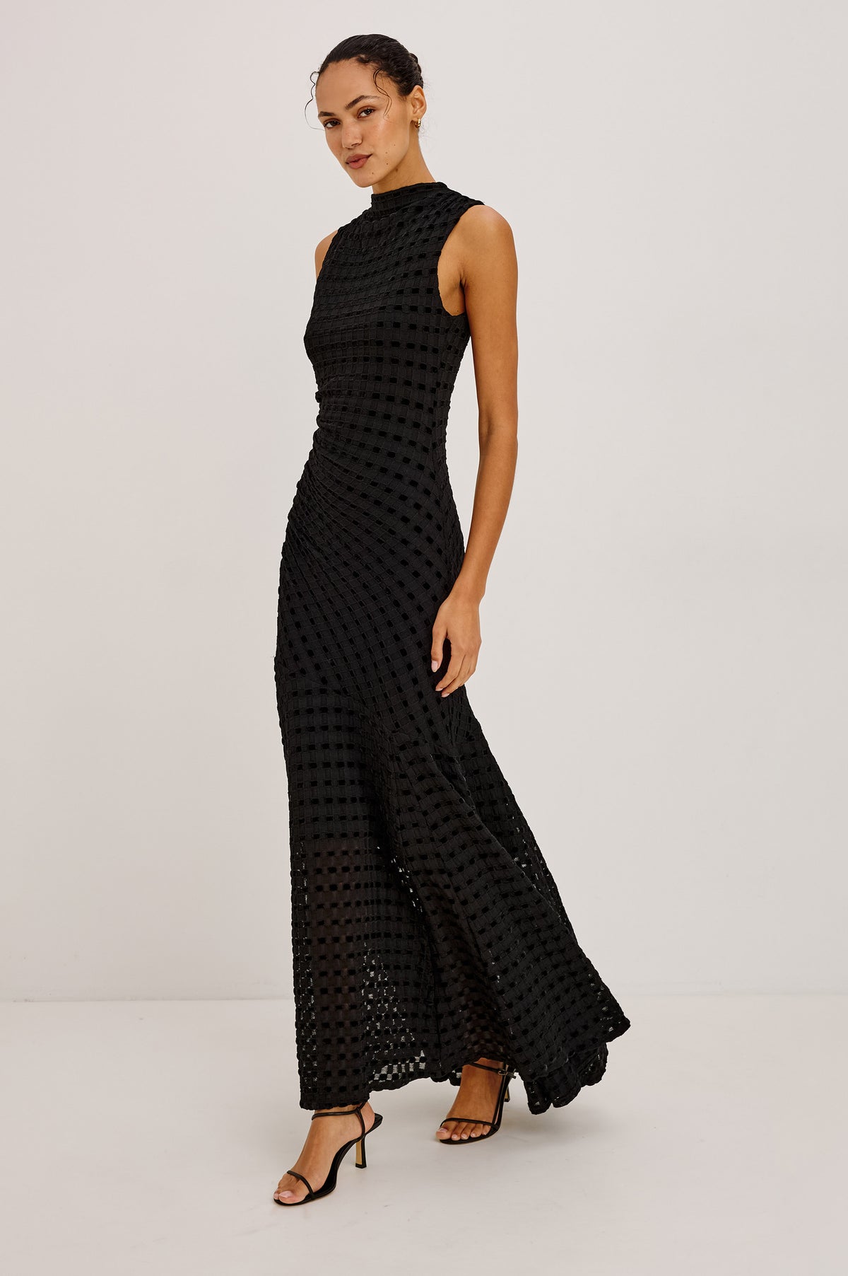 Cosmos Dress in Checkerboard Devoré With Mock Neck, Sleeveless Silhouette, and Ruched Waist in Black Checkerboard Colorway - Upper Body Front View Featured on Model.