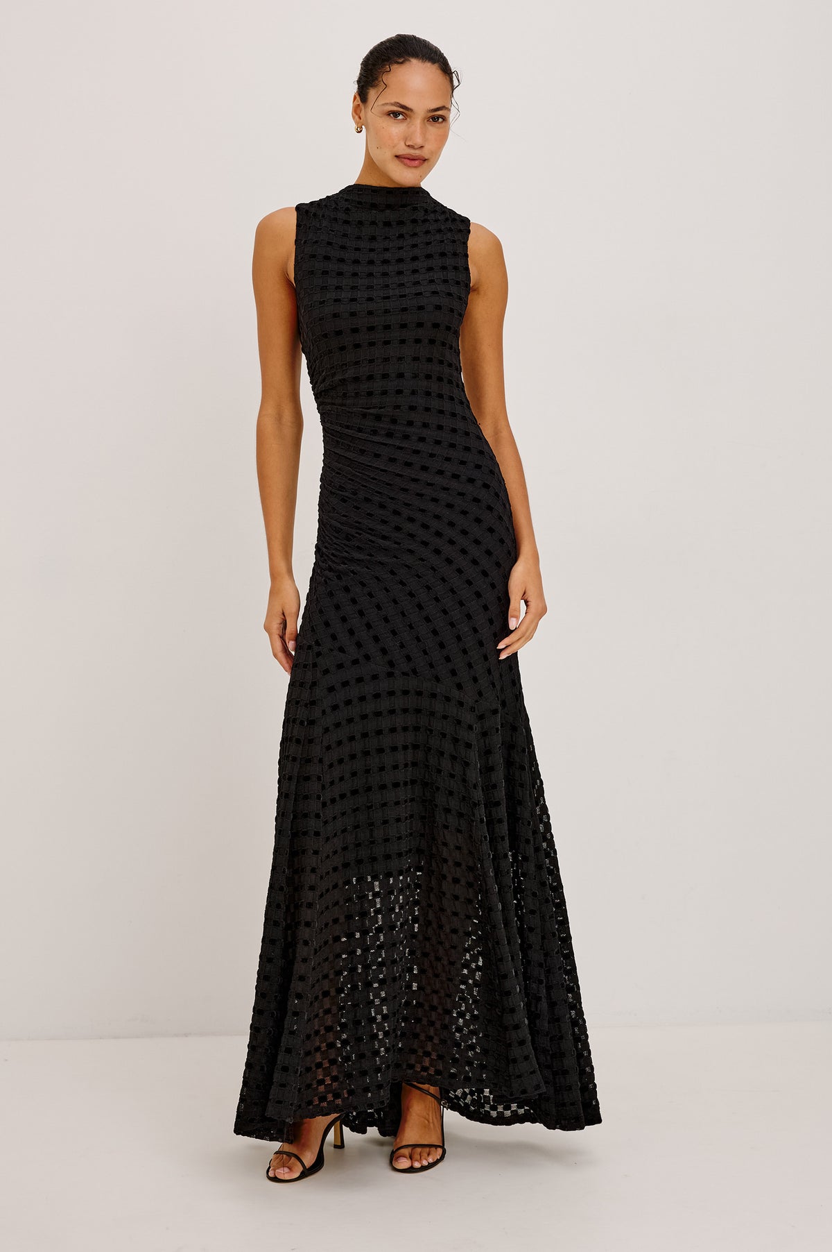 Cosmos Dress in Checkerboard Devoré With Mock Neck, Sleeveless Silhouette, and Ruched Waist in Black Checkerboard Colorway - Front View Featured on Model.