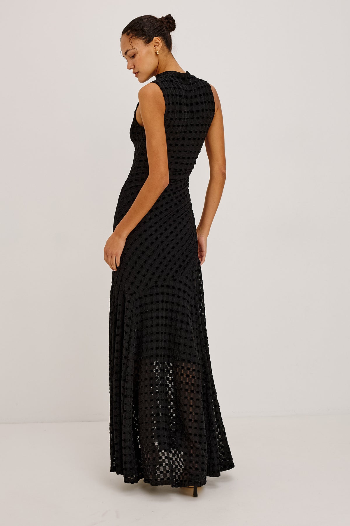 Cosmos Dress in Checkerboard Devoré With Mock Neck, Sleeveless Silhouette, and Ruched Waist in Black Checkerboard Colorway - Upper Body Back View Featured on Model.