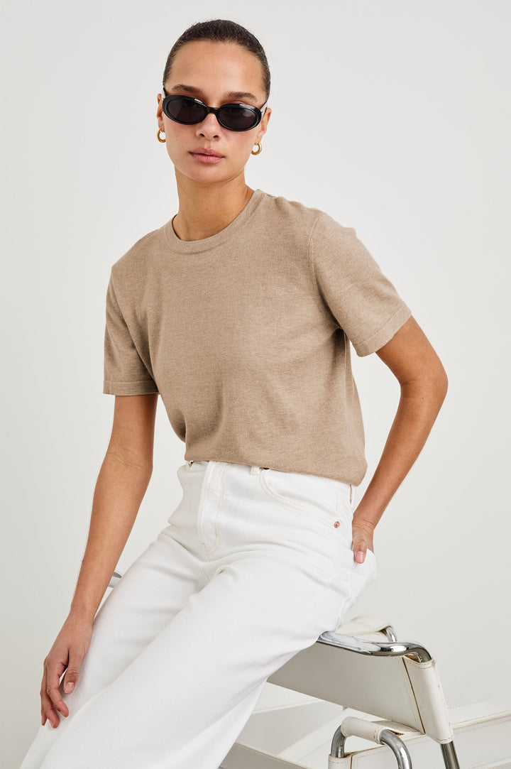 Cotton Cashmere Short Sleeve crew neck T-Shirt in Heather Oat - front view on model, sitting with sunglasses