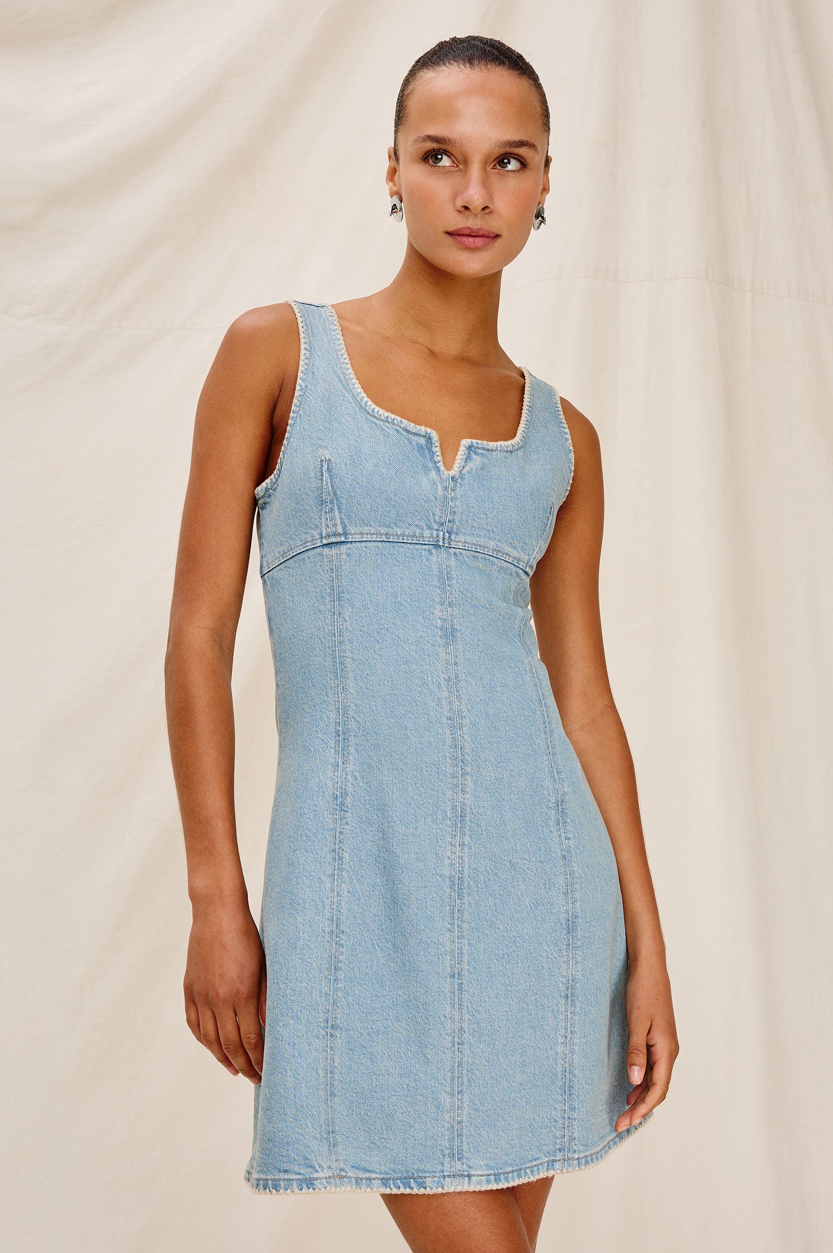 Cove Denim Tank Dress with a Scoop Split neck, Empire Bust, A-line and Above-Knee Length in Capri Colorway.  Front View Shown on Model.