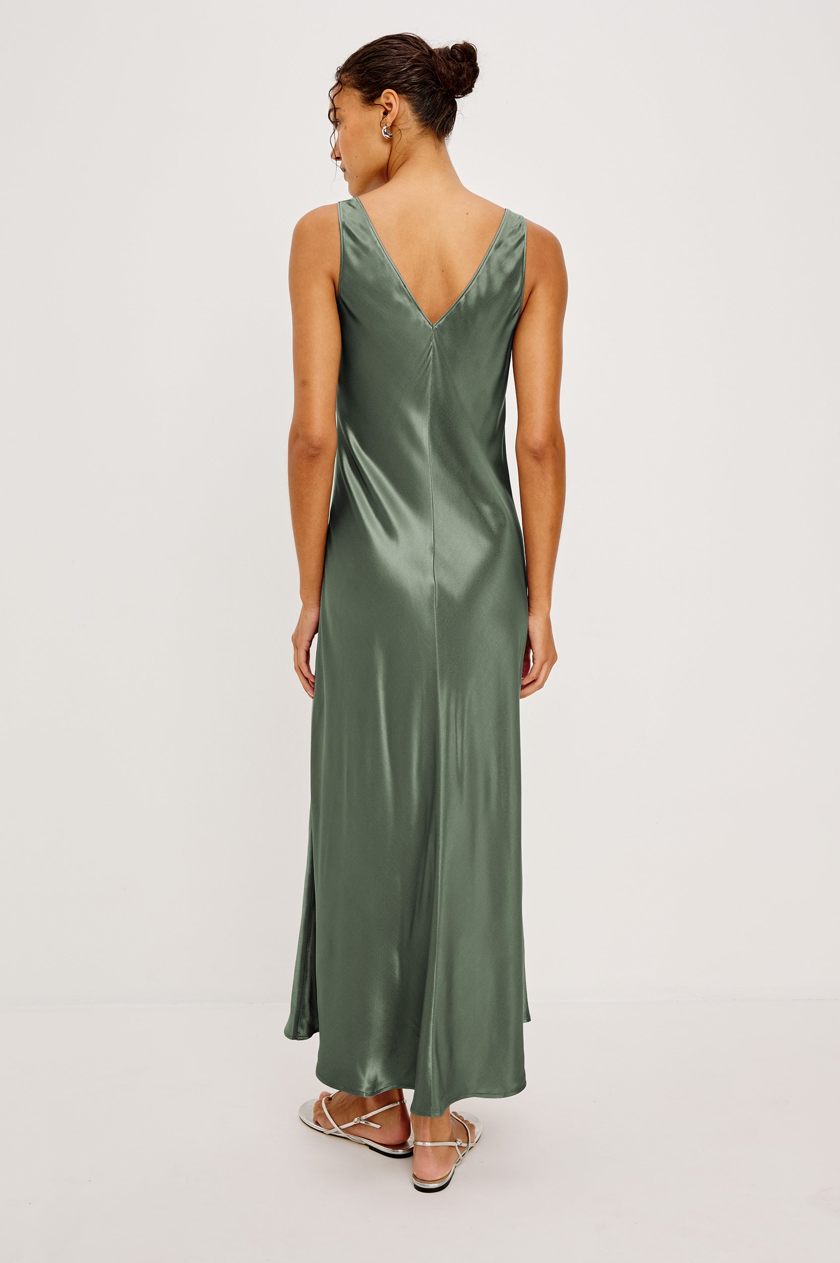 Cressia Midi Dress in Satin With Bias Cut and V-Neckline With Keyhole Cutout and Molded Metallic Jewelry in Ivy Colorway - Full Body Back View Featured on Model