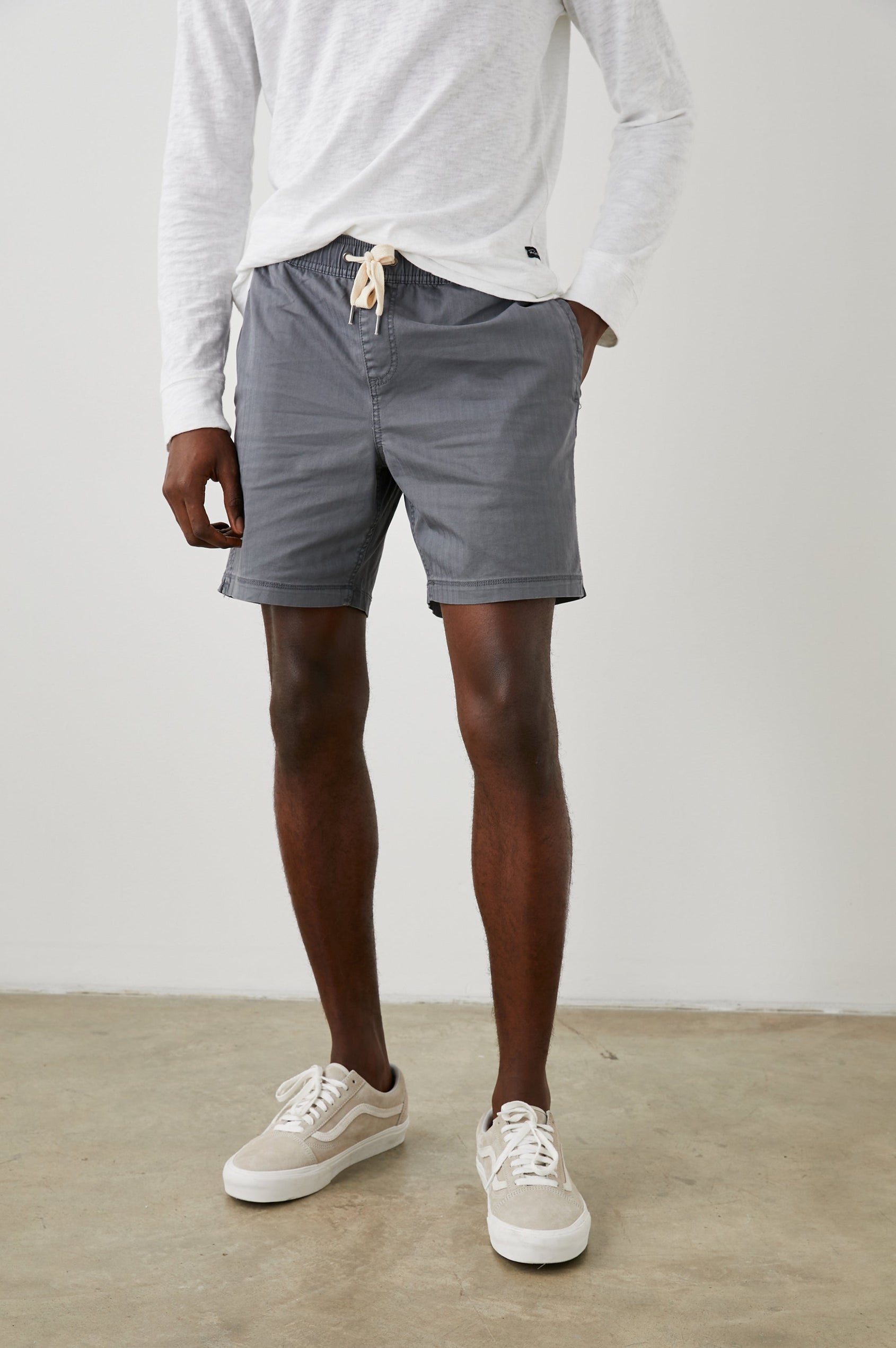Cruz Shorts with a Drawstring Waist, Two Front Pockets, Two Back Button Flap Pockets in Charcoal Colorway - Front View Featured on Model 