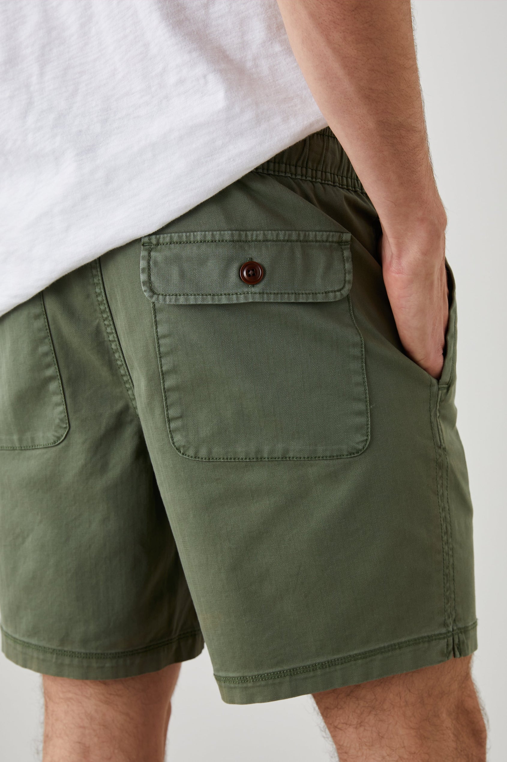 Cruz Shorts with a Drawstring Waist, Two Front Pockets, Two Back Button Flap Pockets in Spring Olive Colorway - Back View Featured on Model 