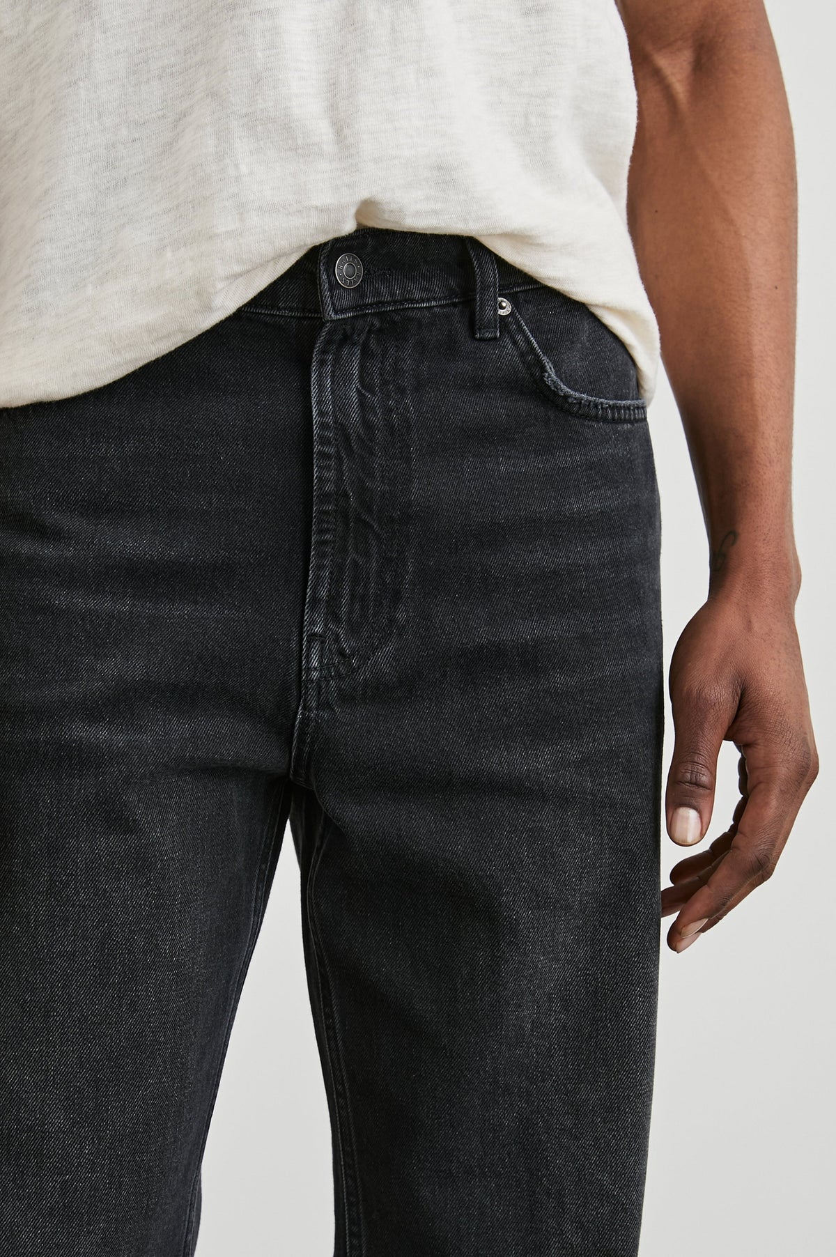 Cutler 90's Loose Jeans with Belt Loops, Two Front Pockets plus a Coin Pocket and Two Back Patch Pockets in Distressed Black Colorway - Front Detail View Featured on Model
