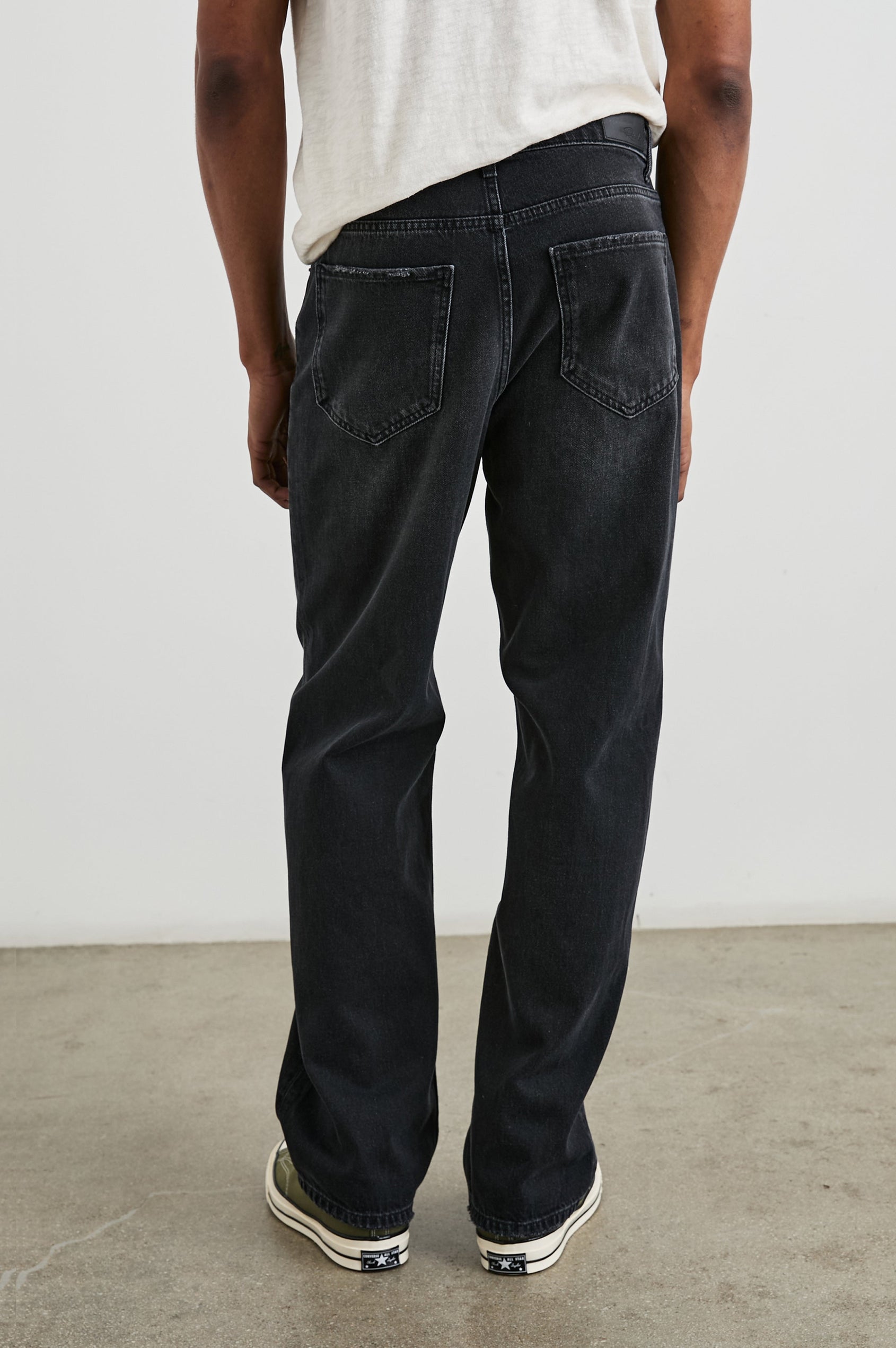 Cutler 90's Loose Jeans with Belt Loops, Two Front Pockets plus a Coin Pocket and Two Back Patch Pockets in Distressed Black Colorway - Back View Featured on Model