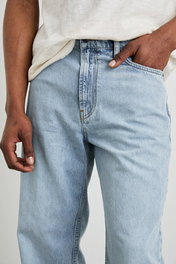 Cutler 90's Loose Jeans with Belt Loops, Two Front Pockets plus a Coin Pocket and Two Back Patch Pockets in Vintage Light Wash Colorway - Front View Featured on Model