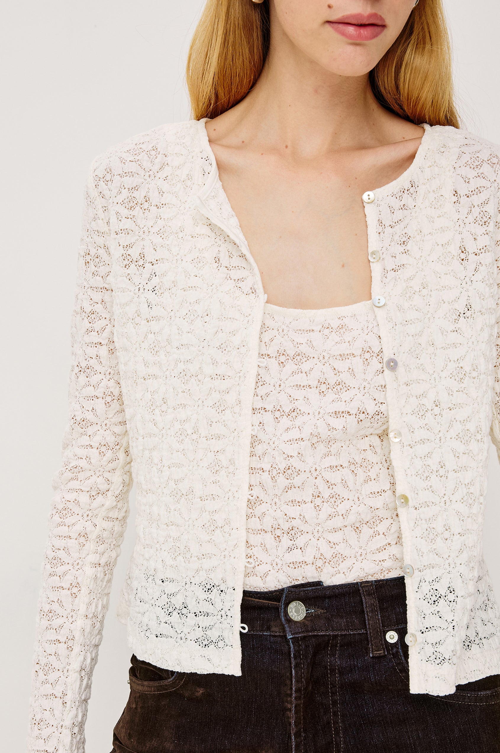 Cyrah Cardigan in Sheer Stretch Lace With Fitted Long Sleeves, and Front Button-and-Loop Closures in Ivory Colorway - Upper Body Close Up View Featured on Model