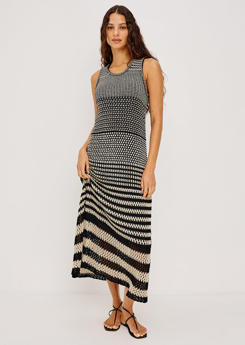 Woman wearing a black and beige striped maxi dress