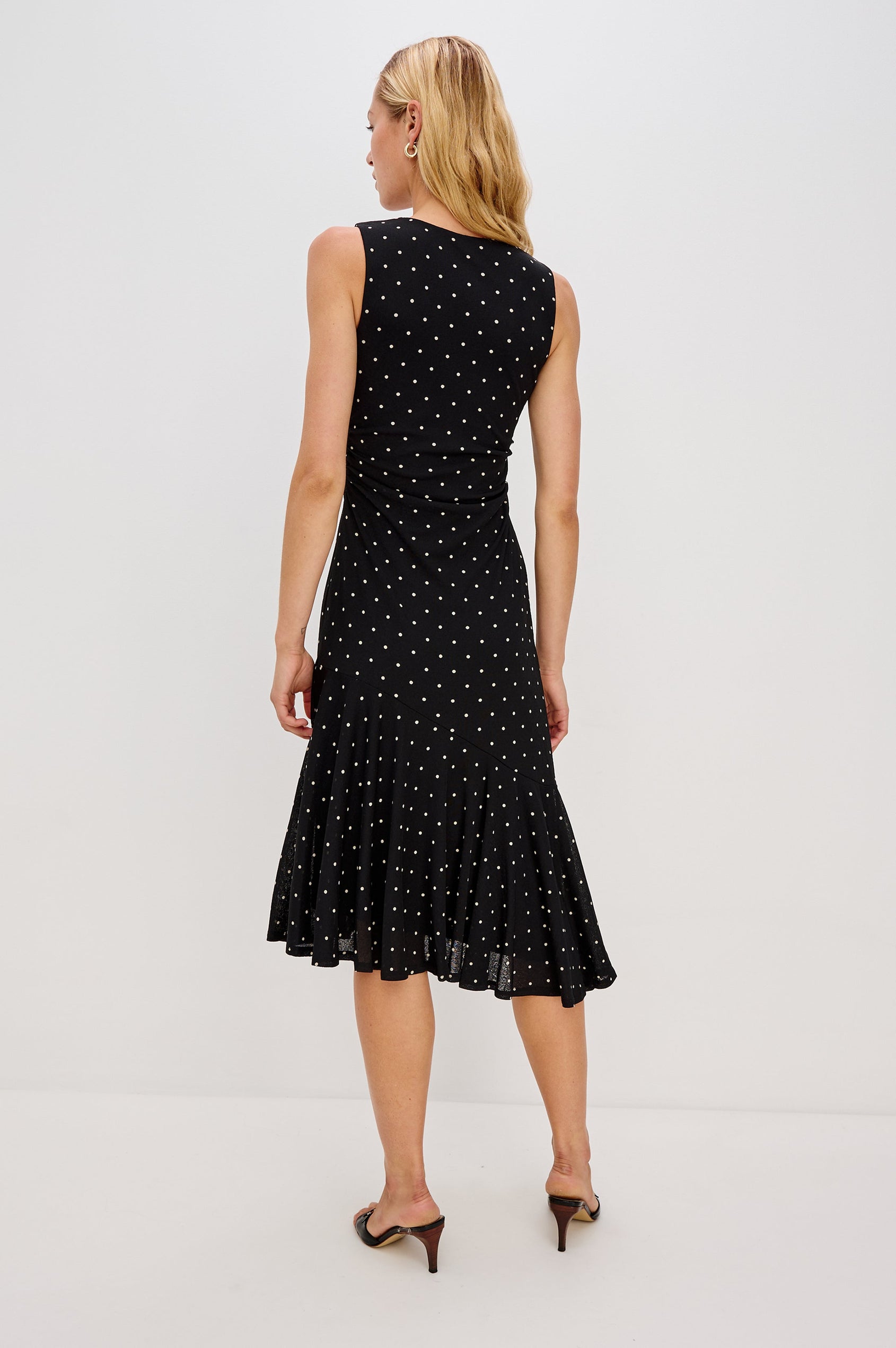 Daija Sleeveless Midi Dress with a Pleated Asymmetrical Hemline, and a Crew Neckline in Polka Dots Colorway - Back View Featured on Model
