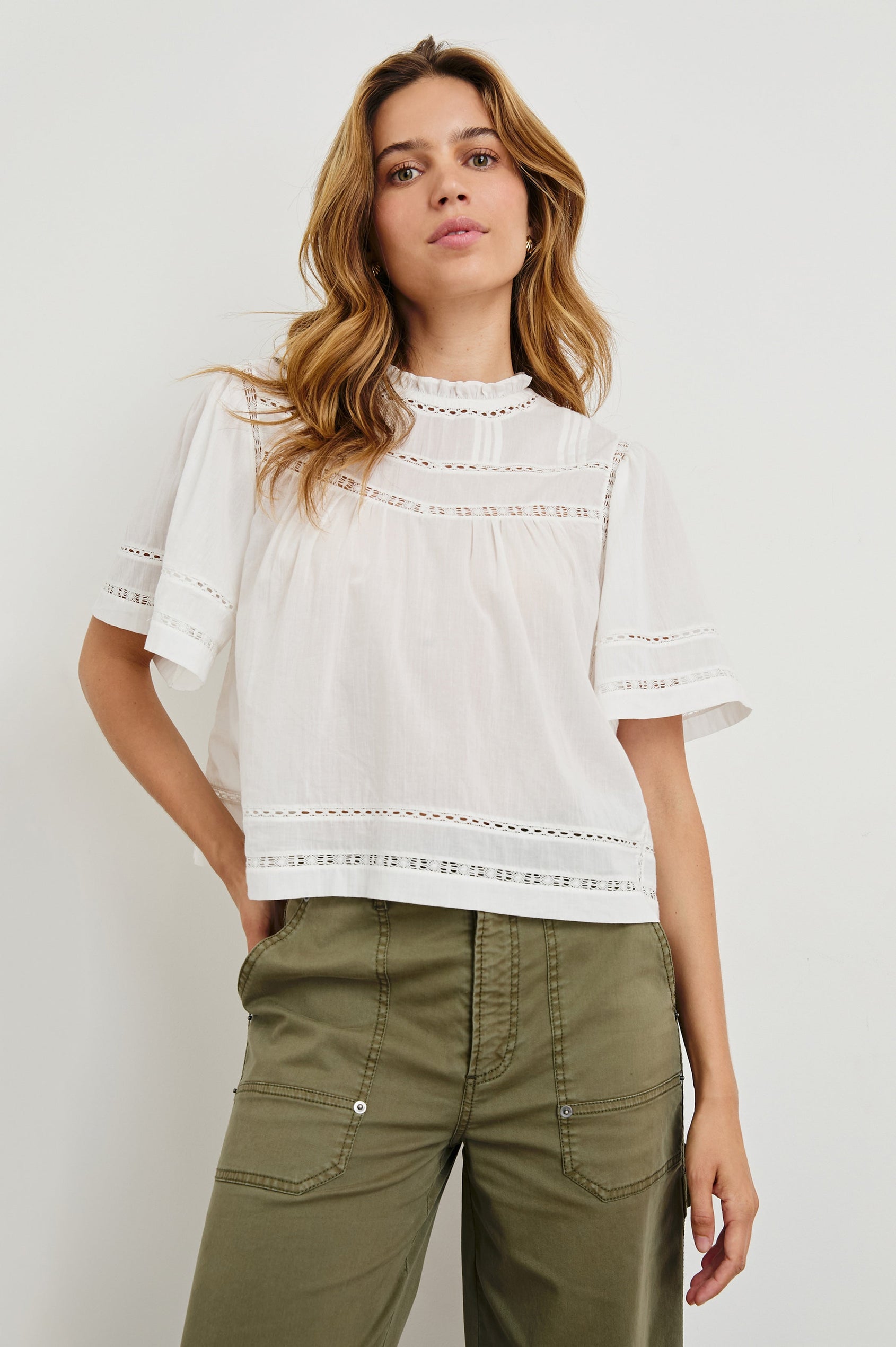 Daisy Short Sleeve Top with Shirred Collar, Trimmed with Cutouts, Keyhole with button in back in White Colorway - Front View Featured on Model