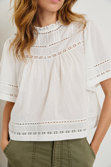 Daisy Short Sleeve Top with Shirred Collar, Trimmed with Cutouts, Keyhole with button in back in White Colorway - Front View Featured on Model