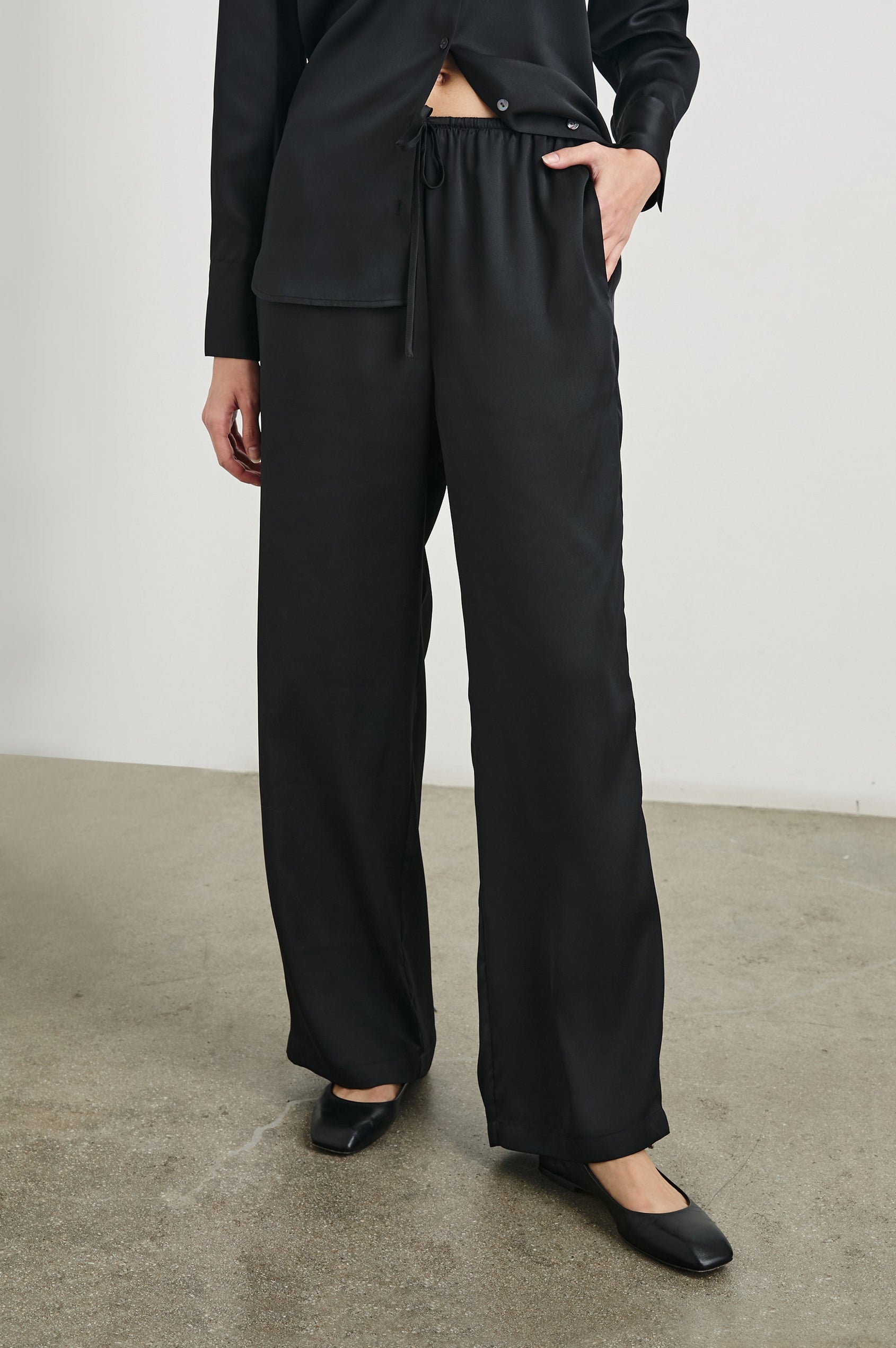 Damini Pants with a Drawstring Waist and Two Front Pockets in Black Colorway - Front View Featured on Model