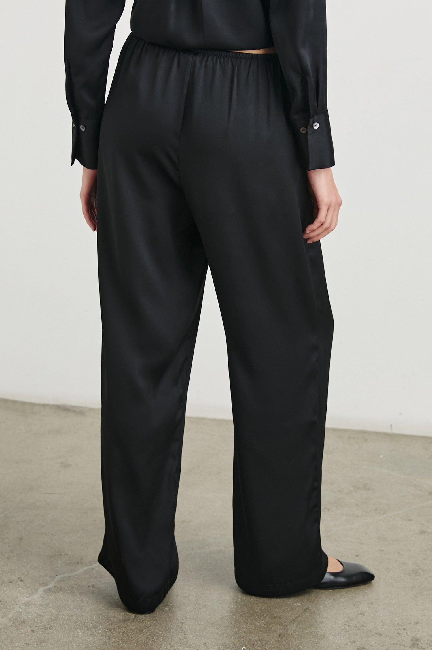 Damini Pants with a Drawstring Waist and Two Front Pockets in Black Colorway - Back View Featured on Model