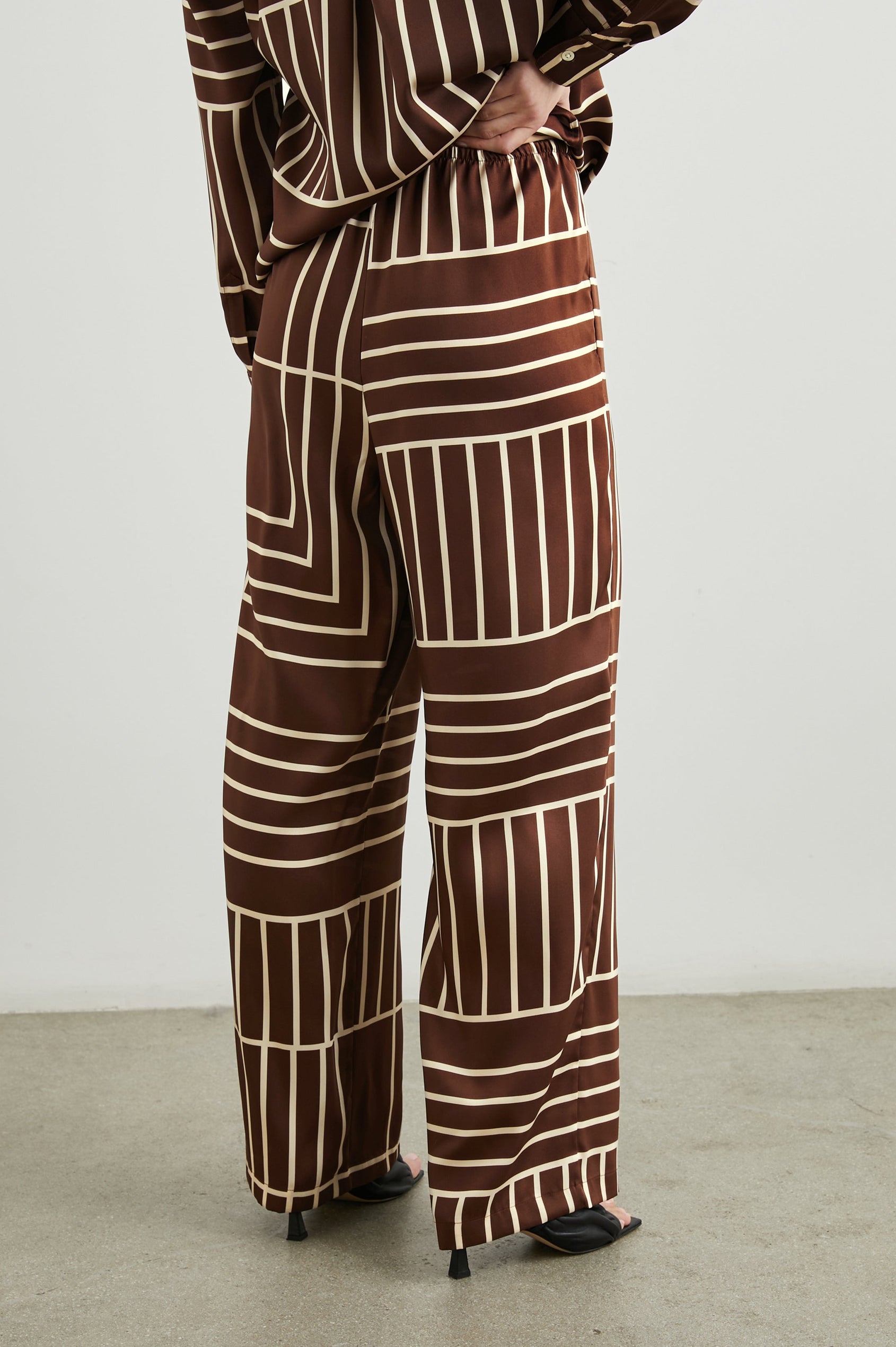 Damini Pants with a Drawstring Waist and Two Front Pockets in Brown Line Art Colorway, white lines on brown - Back View Featured on Model