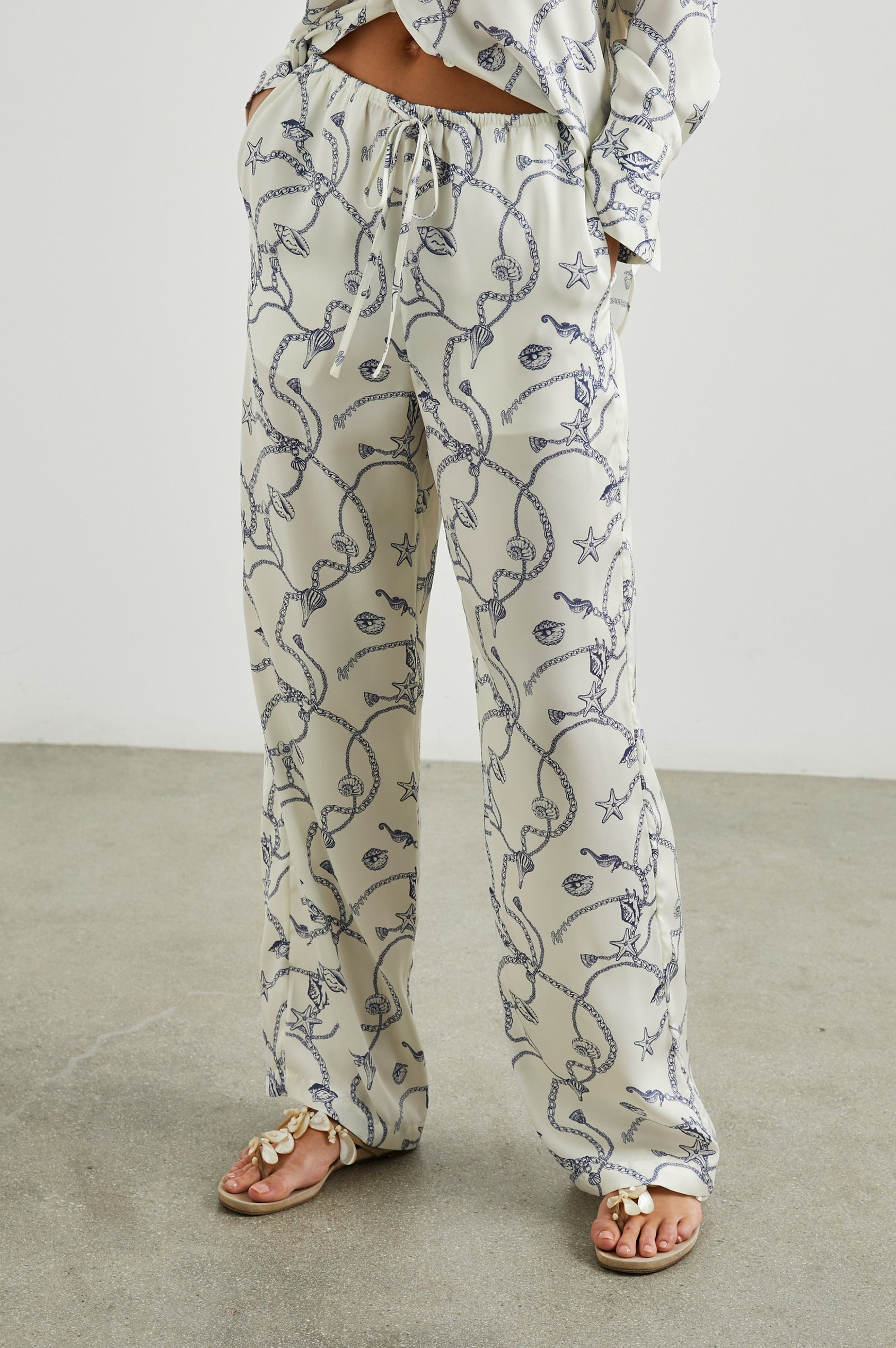 Damini Pants with a Drawstring Waist and Two Front Pockets in Nautical Chain Colorway, with a blue Nautical pattern on white - Front View Featured on Model
