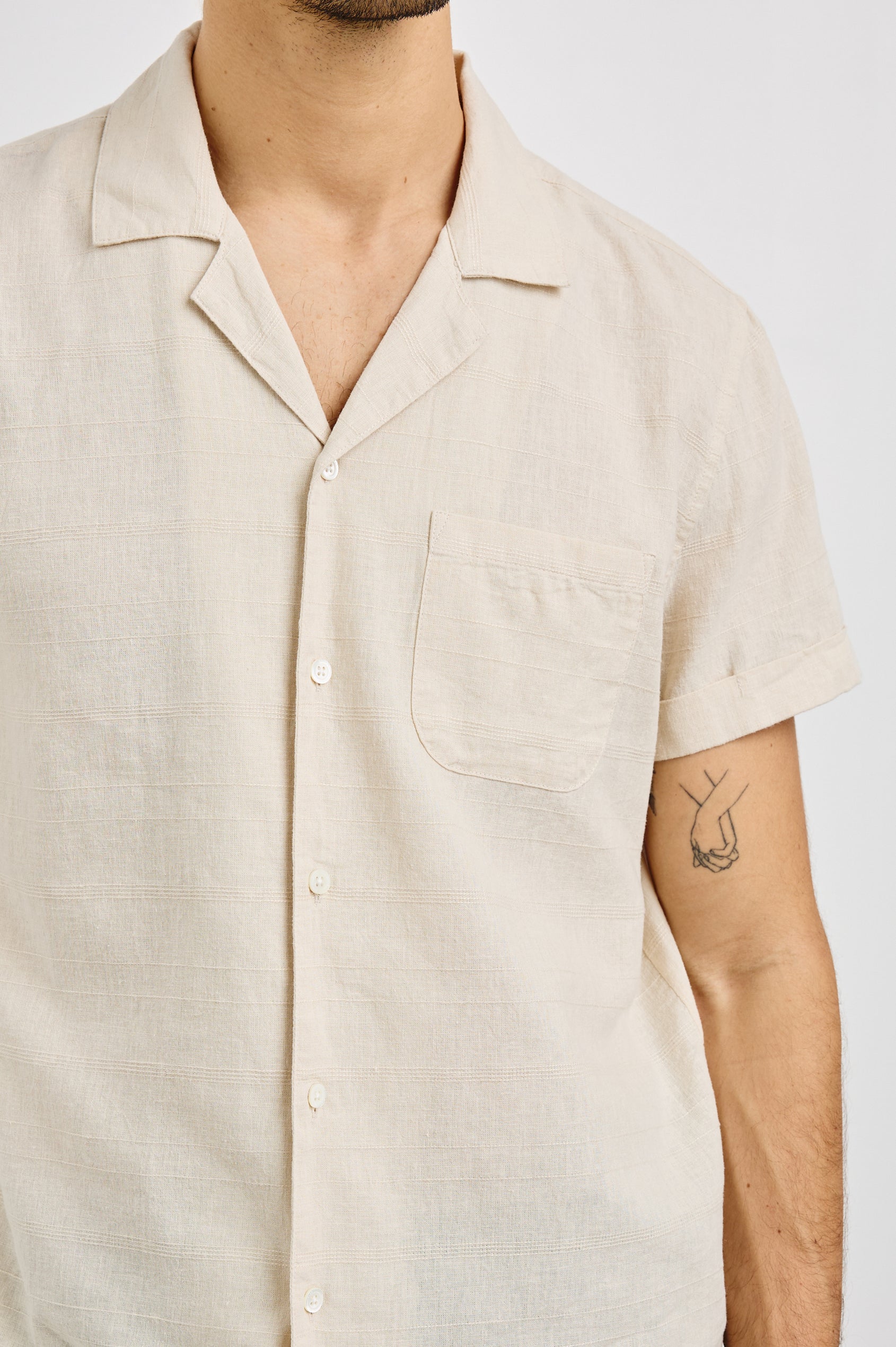 Davis Short Sleeve Button Up with a Chest Patch Pocket, Rolled Cuffs and Textured Horizontal Stripes in Nougat Colorway - Front View Featured on Model