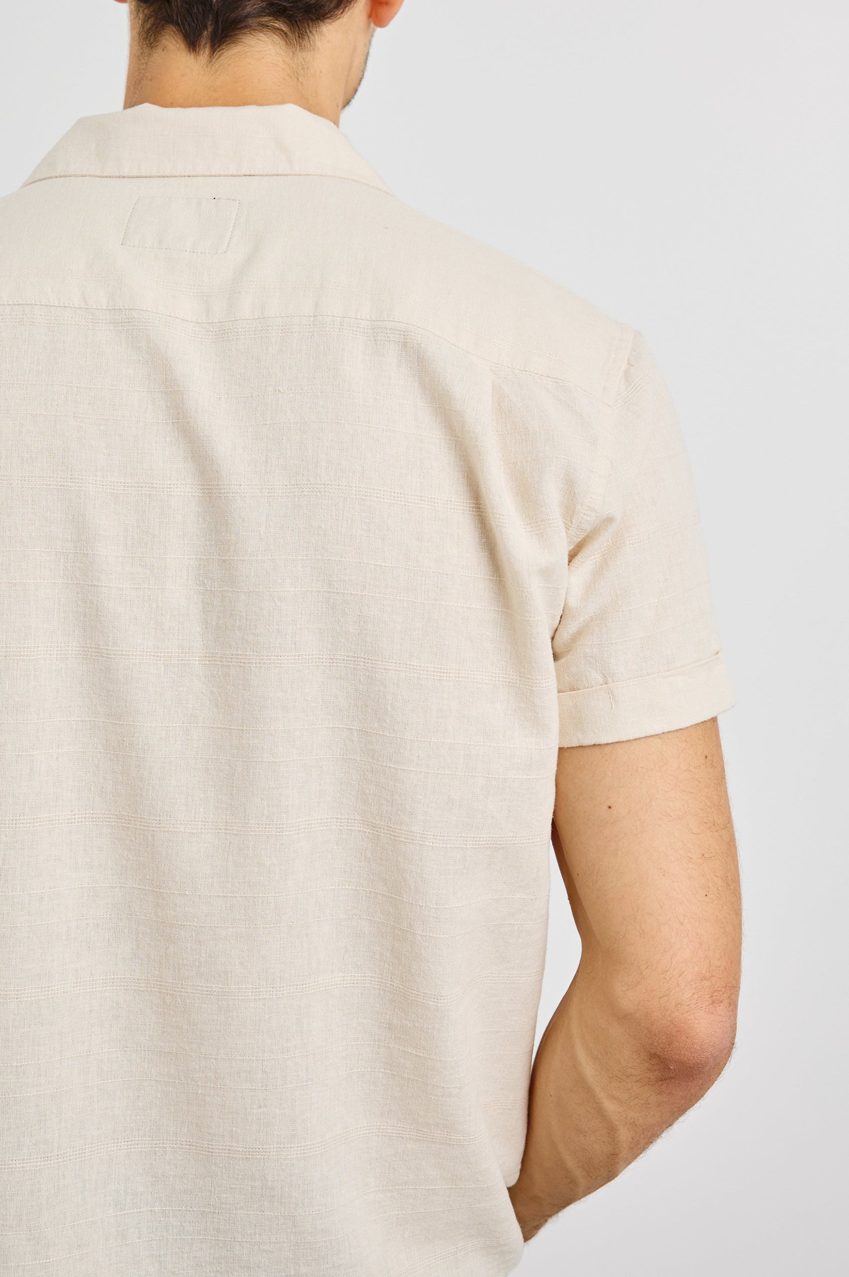 Davis Short Sleeve Button Up with a Chest Patch Pocket, Rolled Cuffs and Textured Horizontal Stripes in Nougat Colorway - Back View Featured on Model