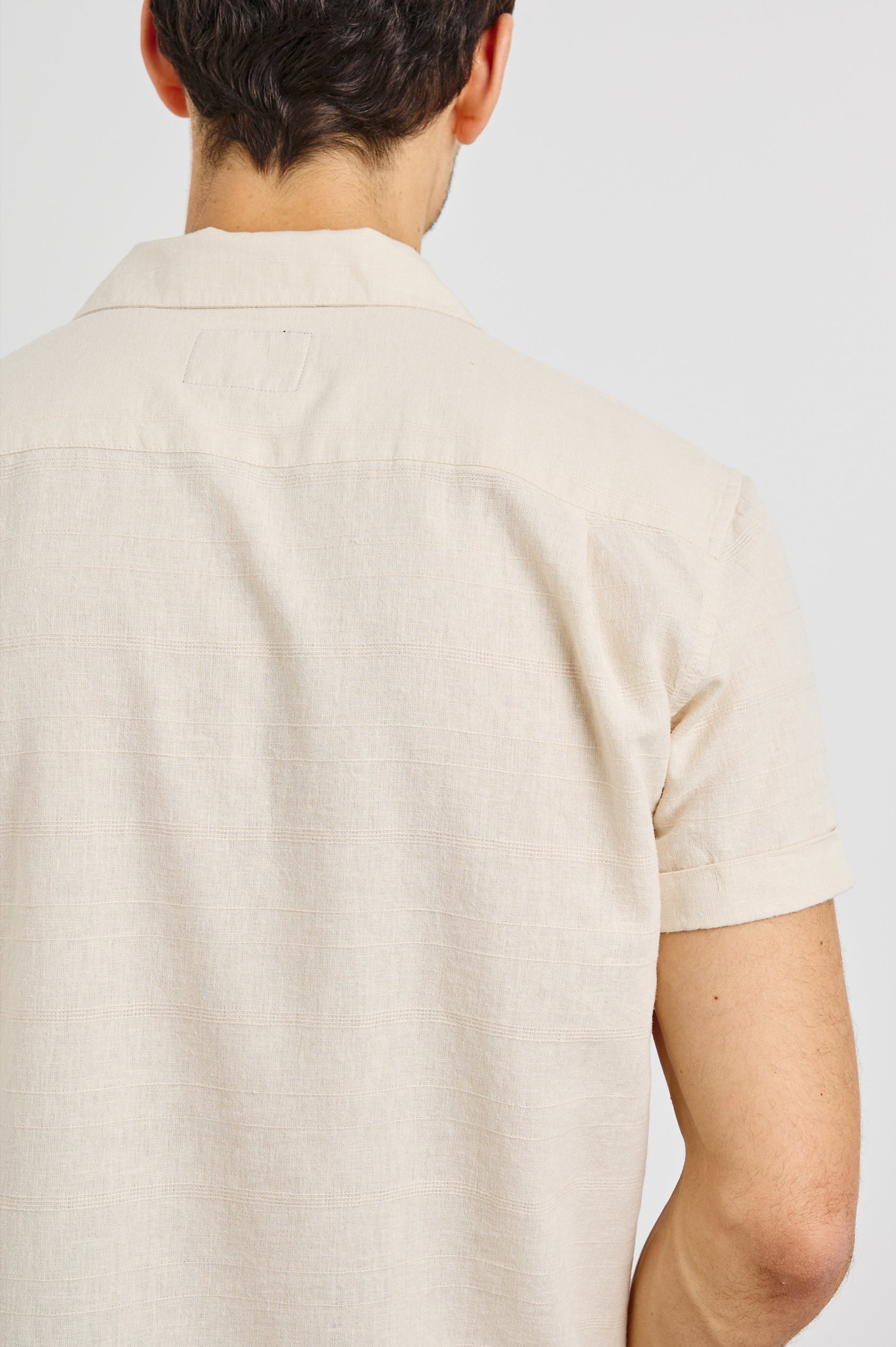 Davis Short Sleeve Button Up with a Chest Patch Pocket, Rolled Cuffs and Textured Horizontal Stripes in Nougat Colorway - Back View Featured on Model