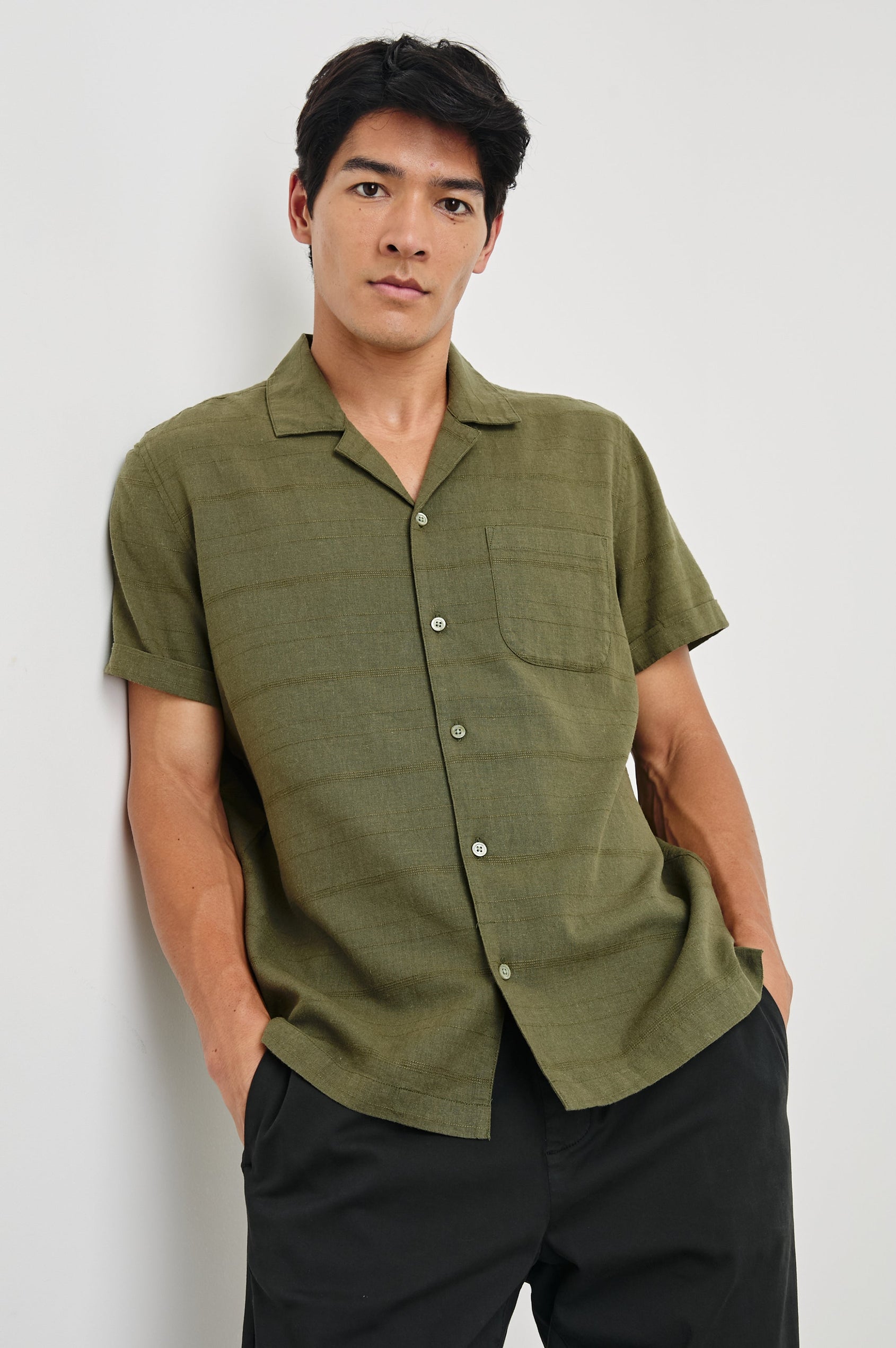 Davis Short Sleeve Button Up with a Chest Patch Pocket, Rolled Cuffs and Textured Horizontal Stripes in True Olive Colorway - Front View Featured on Model