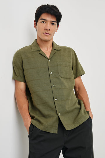 Davis Short Sleeve Button Up with a Chest Patch Pocket, Rolled Cuffs and Textured Horizontal Stripes in True Olive Colorway - Front View Featured on Model