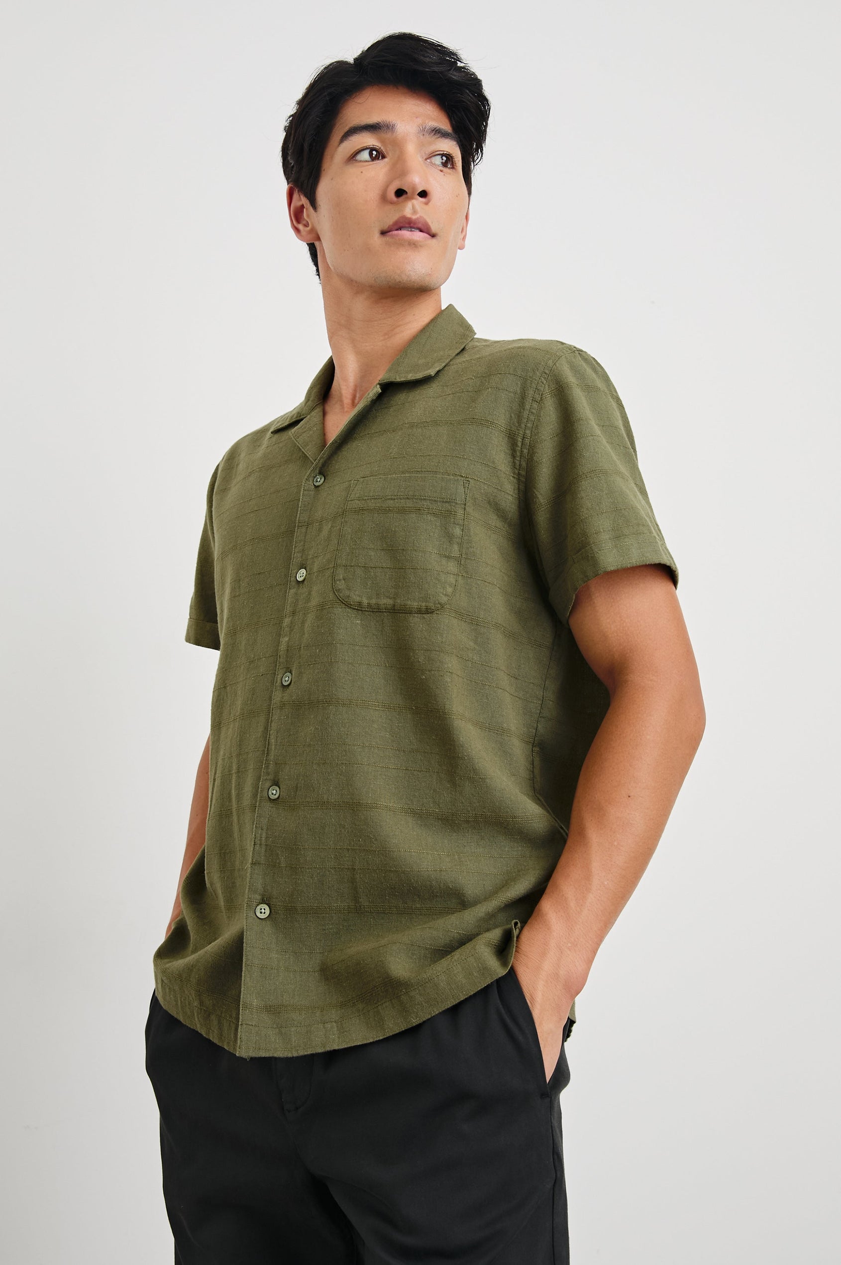 Davis Short Sleeve Button Up with a Chest Patch Pocket, Rolled Cuffs and Textured Horizontal Stripes in True Olive Colorway - Front View Featured on Model