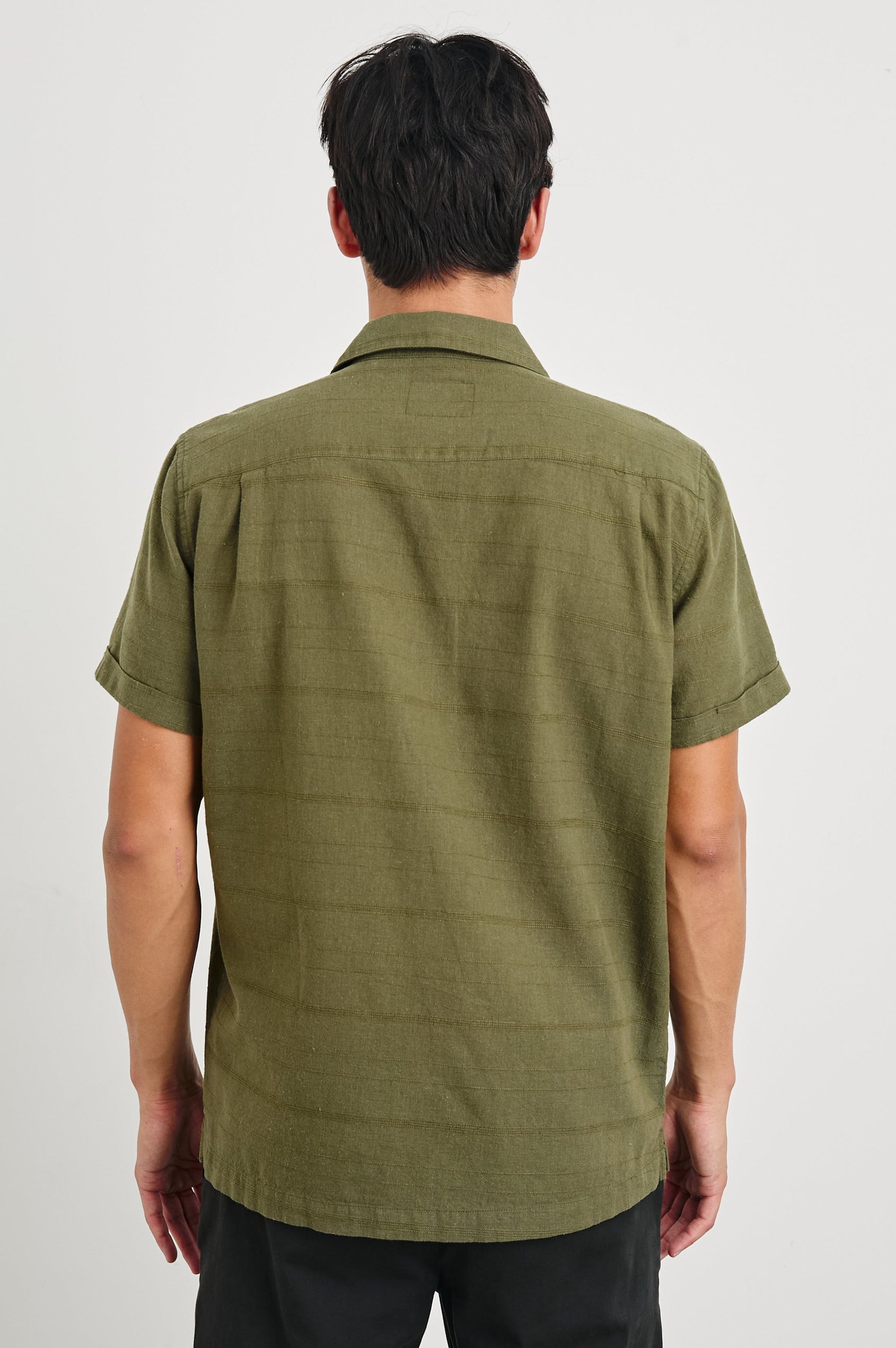 Davis Short Sleeve Button Up with a Chest Patch Pocket, Rolled Cuffs and Textured Horizontal Stripes in True Olive Colorway - Back View Featured on Model