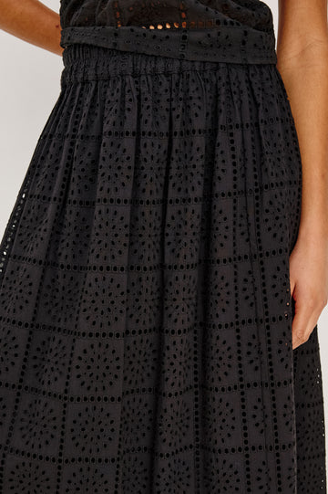 Dax A-Line Maxi Skirt With Grid and Floral Cutwork Embroidery, Elastic Waistband, and is Fully Lined in Black Grid Embroidery Embroidery Colorway - Lower Body Close Up Front View Featured on Model