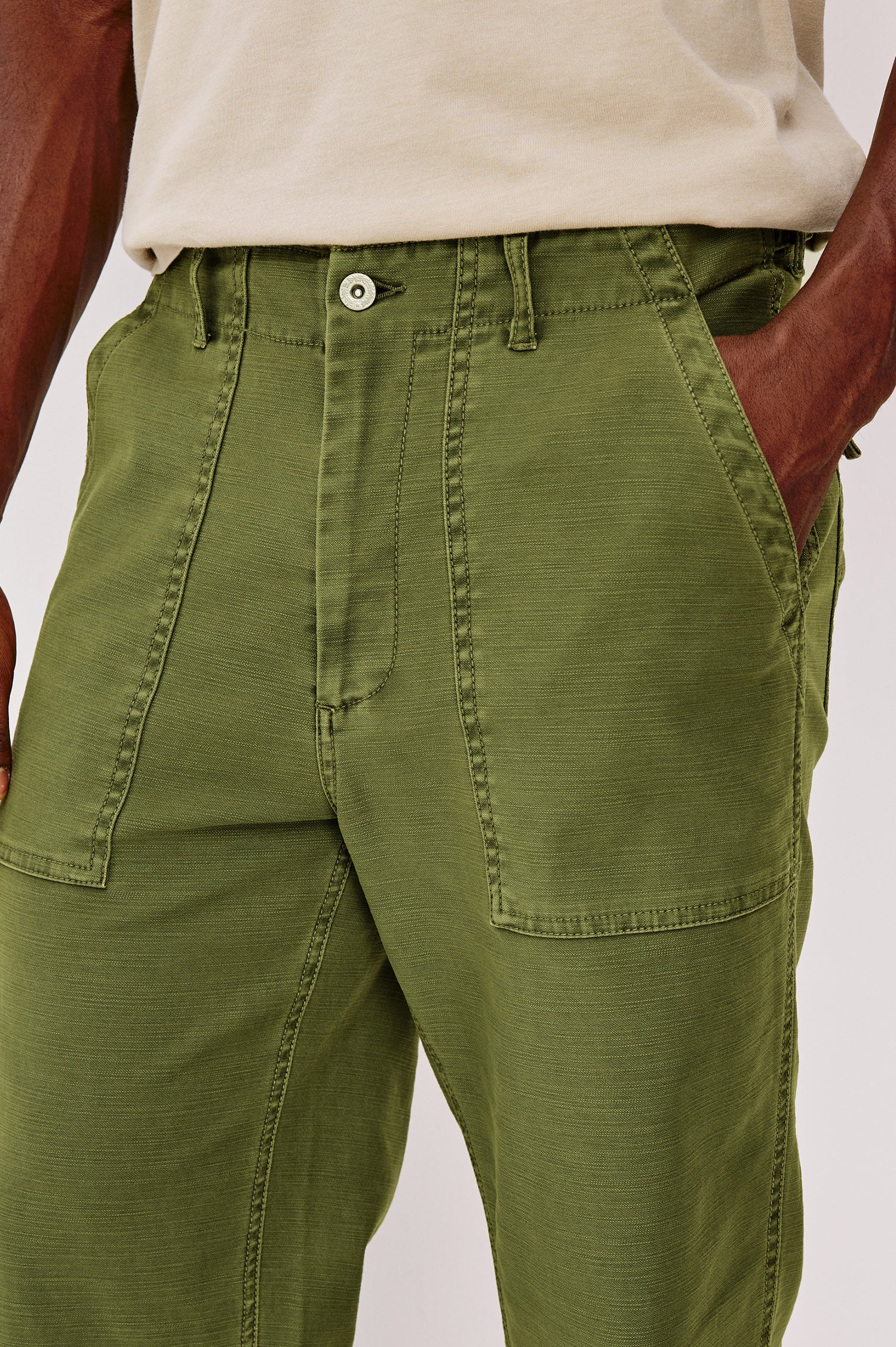 Decker Relaxed Straight Leg Workwear Pant in Stretch Cotton With Lived-In Wash, Zip Fly, and Side and Back Buttoned-Flap Pockets in Olive Colorway - Lower Body Close Up Front View Featured on Model