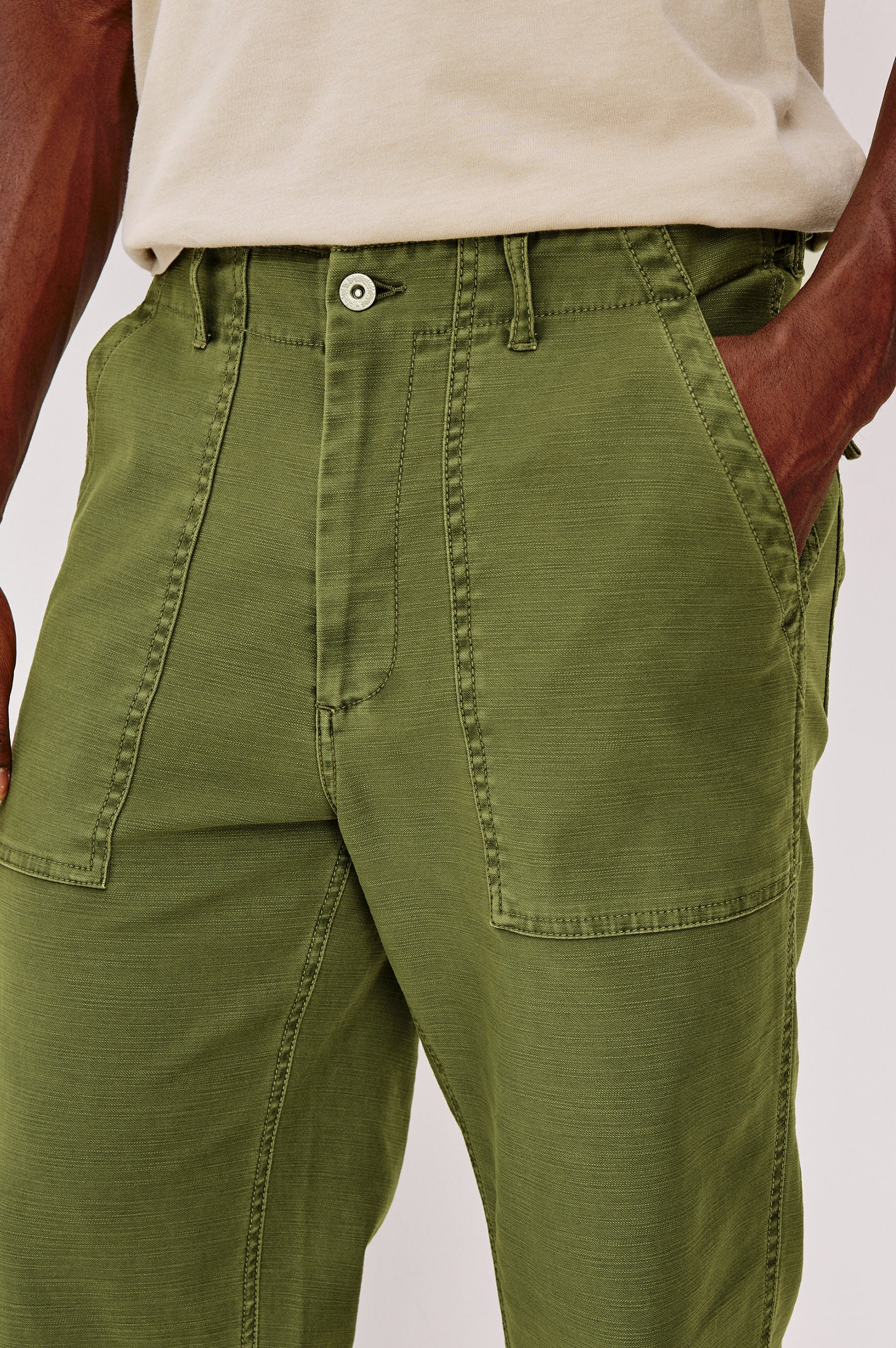 Decker Relaxed Straight Leg Workwear Pant in Stretch Cotton With Lived-In Wash, Zip Fly, and Side and Back Buttoned-Flap Pockets in Olive Colorway - Lower Body Close Up Front View Featured on Model