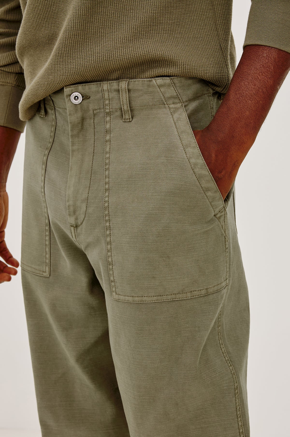 Decker Relaxed Straight Leg Workwear Pant in Stretch Cotton With Lived-In Wash, Zip Fly, and Side and Back Buttoned-Flap Pockets in Terra Colorway - Lower Body Close Up Front View Featured on Model