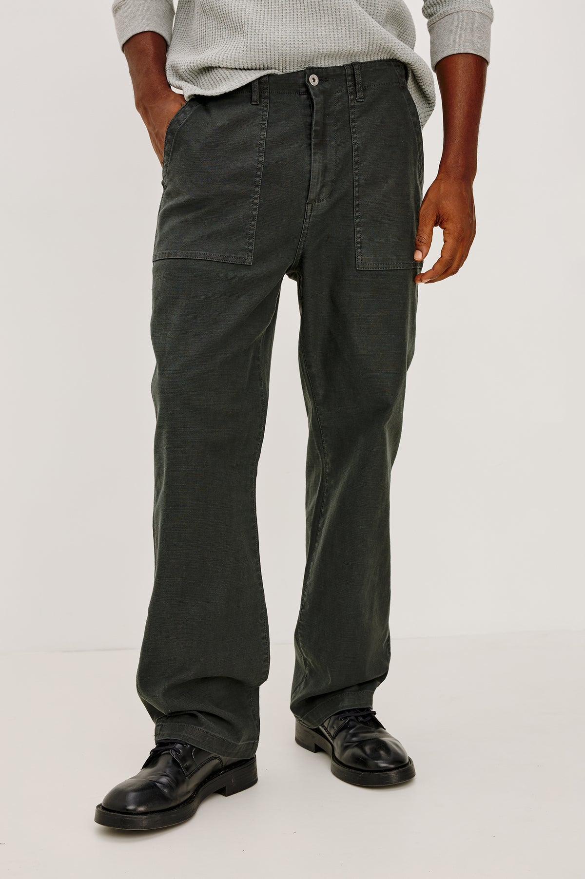 Decker Relaxed Straight Leg Workwear Pant in Stretch Cotton With Lived-In Wash, Zip Fly, and Side and Back Buttoned-Flap Pockets in Washed Black Colorway - Lower Body Front View Featured on Model