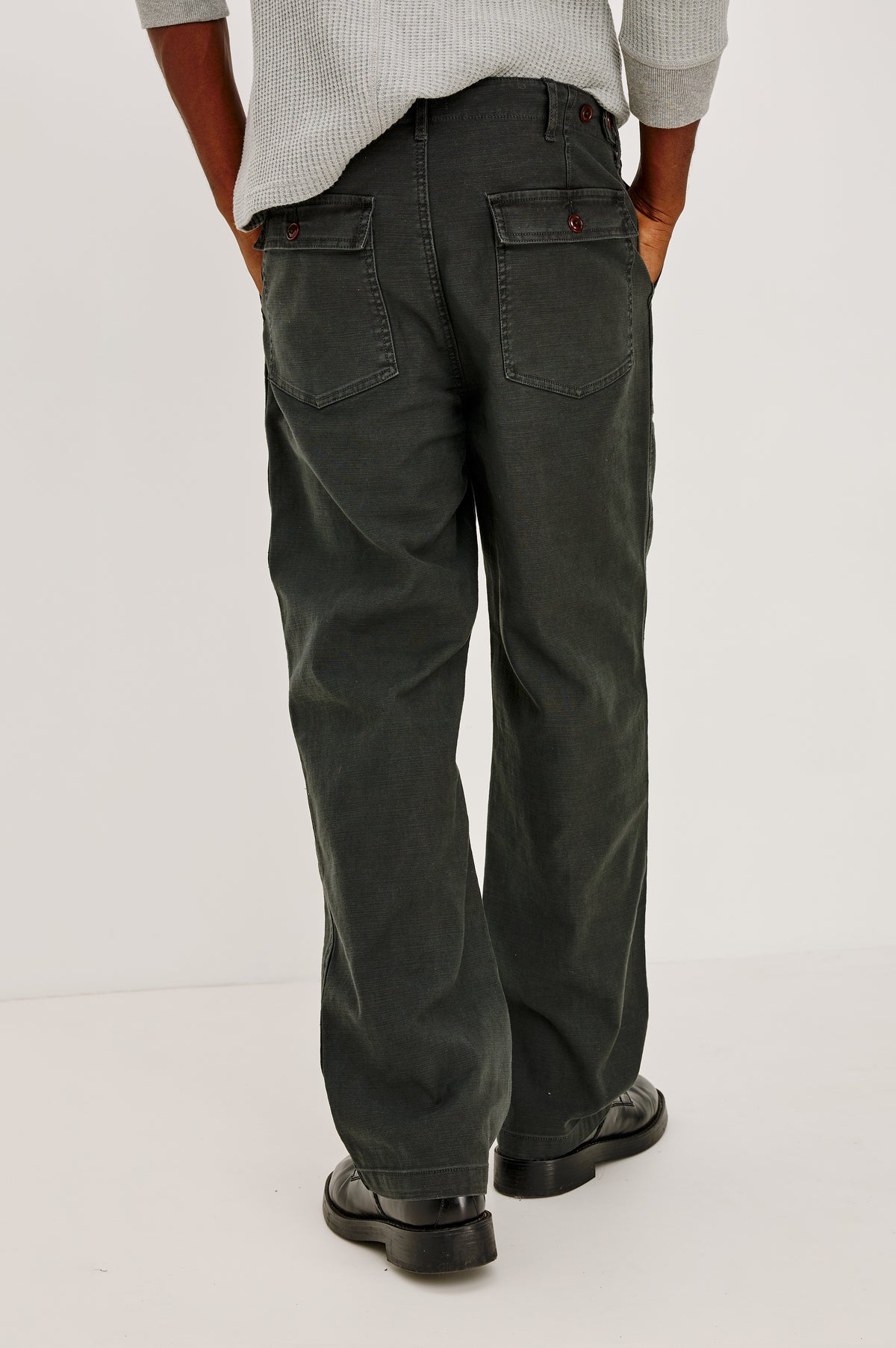 Decker Relaxed Straight Leg Workwear Pant in Stretch Cotton With Lived-In Wash, Zip Fly, and Side and Back Buttoned-Flap Pockets in Washed Black Colorway - Lower Body Back View Featured on Model