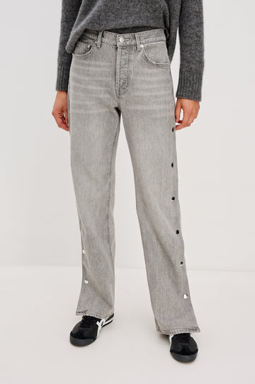 Del Mar low slung baggy boyfriend 5-pocket jean with silver metal studs on side seams and a slit at hem in a grey wash Stone Grey - front view featured on model.