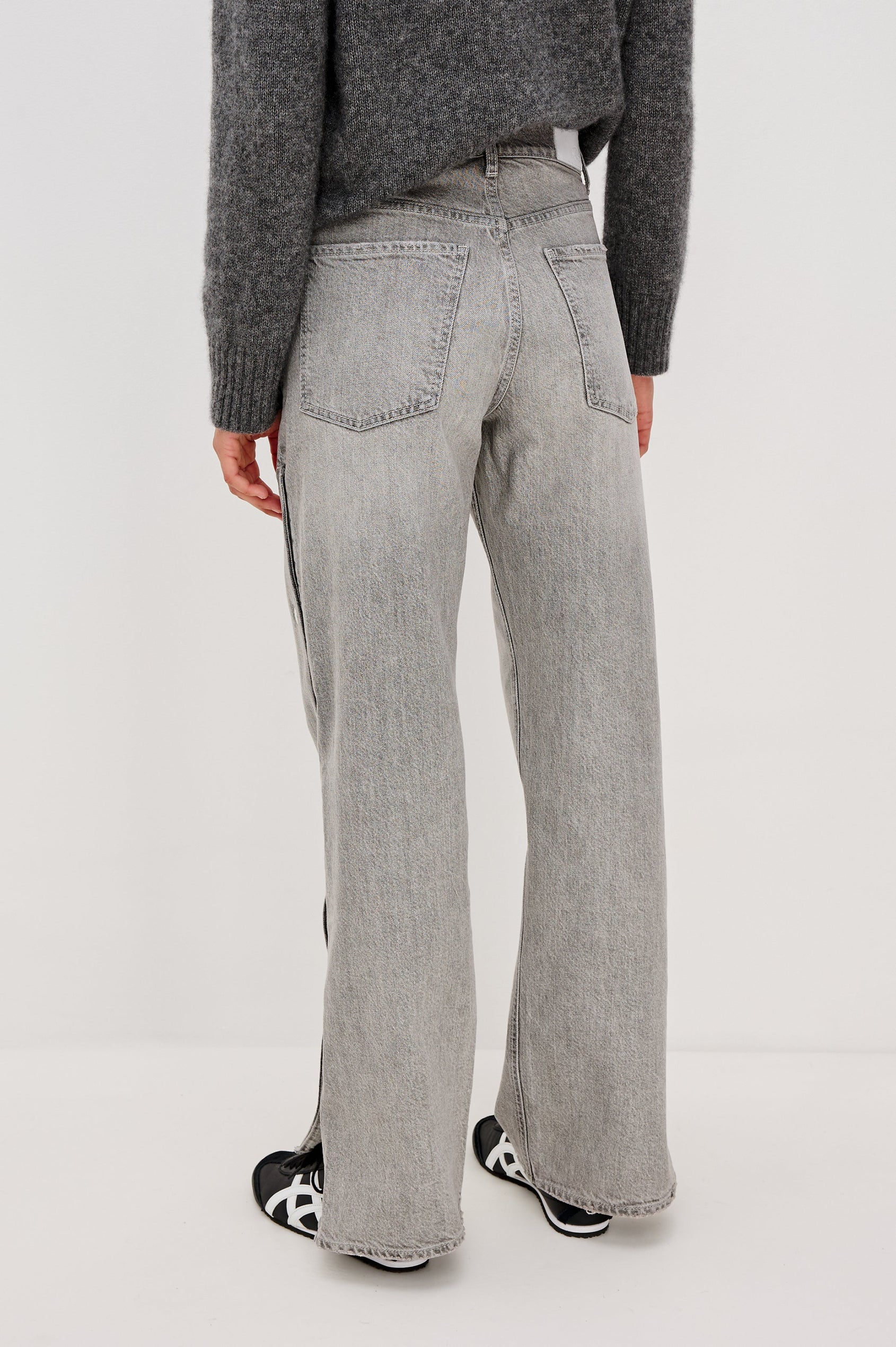 Del Mar low slung baggy boyfriend 5-pocket jean with silver metal studs on side seams and a slit at hem in a grey wash Stone Grey - back view featured on model.