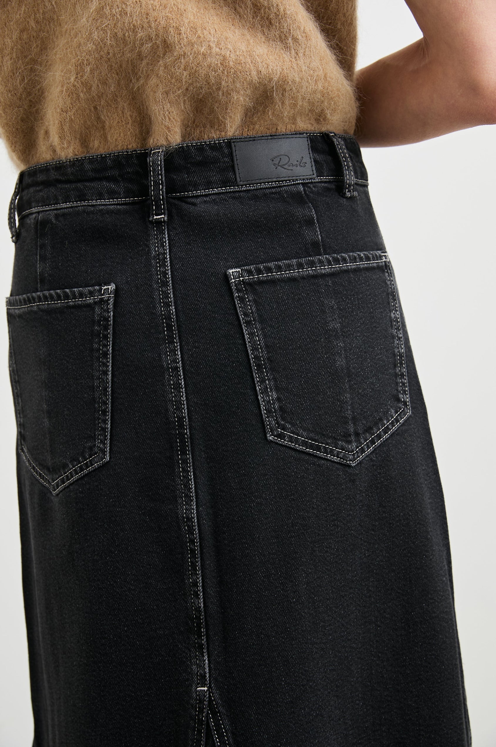 Del Rey Denim Midi Skirt with Western-Style Seams, Belt Loops, Two Front Pockets and Two Back Patch Pockets in Black Sand Colorway - Back View Featured on Model