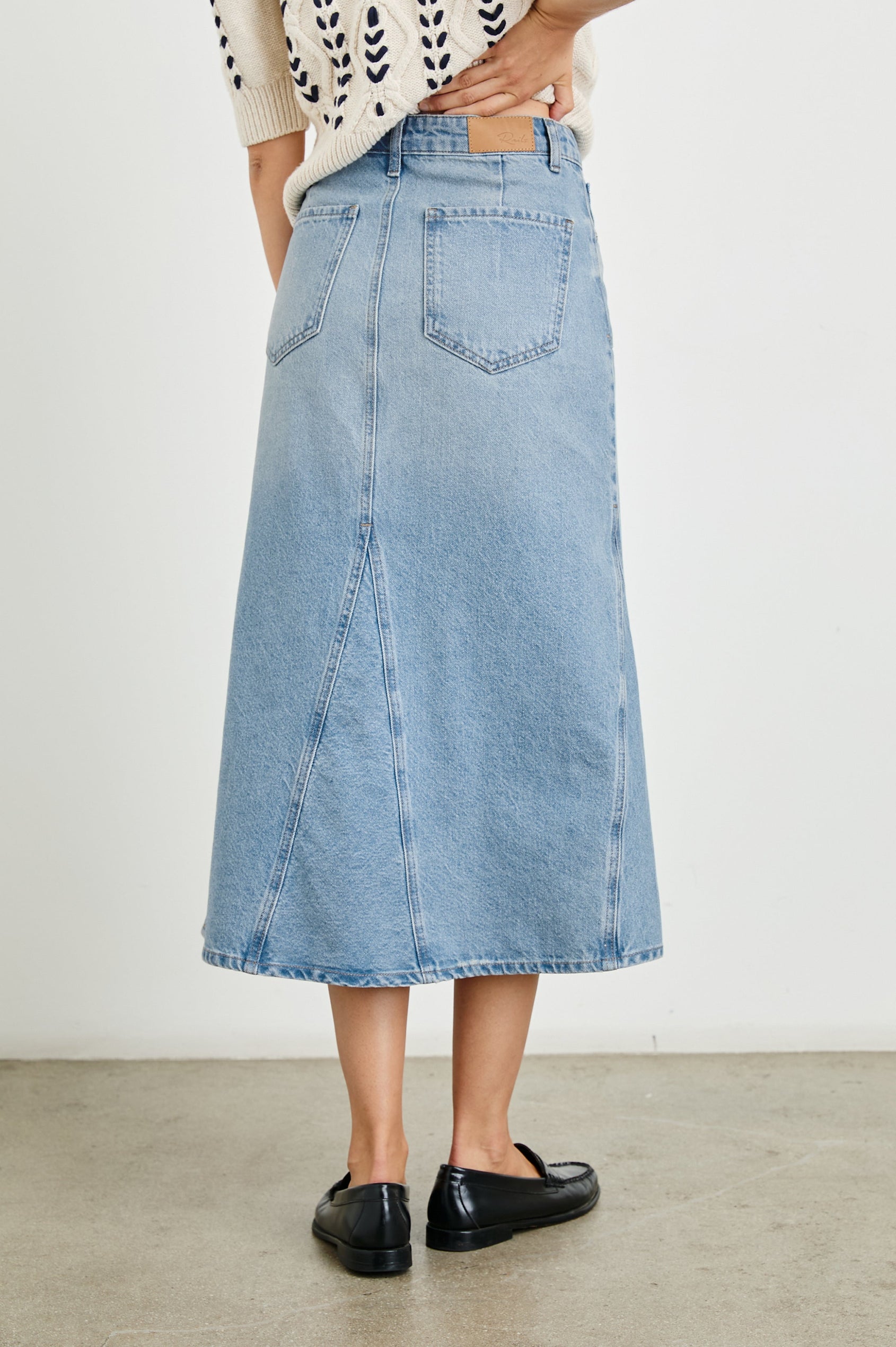 Del Rey Denim Midi Skirt with Western-Style Seams, Belt Loops, Two Front Pockets and Two Back Patch Pockets in Original Blue Colorway - Back View Featured on Model