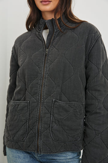 Denver Jacket with a Zip Up Closure, Two Front Patch Pockets and Quilted Stitching in Faded Black Colorway - Front View Featured on Model