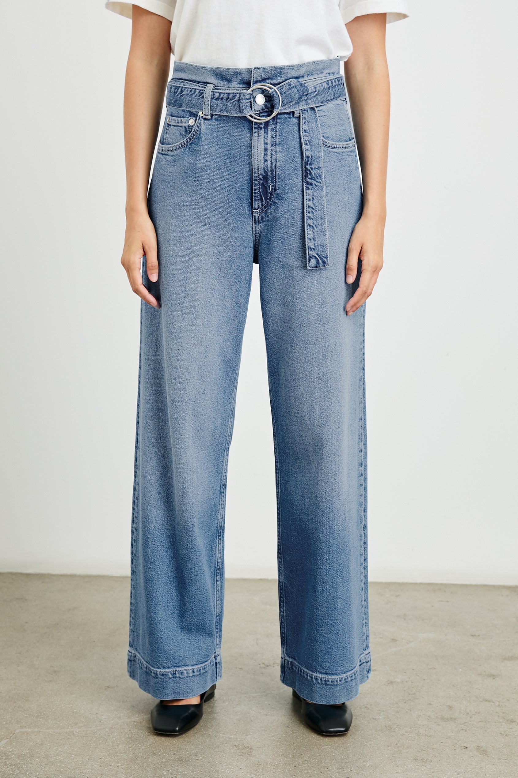 Descanso Wide Leg Denim Pants with Belt Loops, a Fabric O-Ring Belt, Two Front Pockets Plus a Coin Pocket and Two Back Patch Pockets in Cadet Blue Colorway - Front View Featured on Model